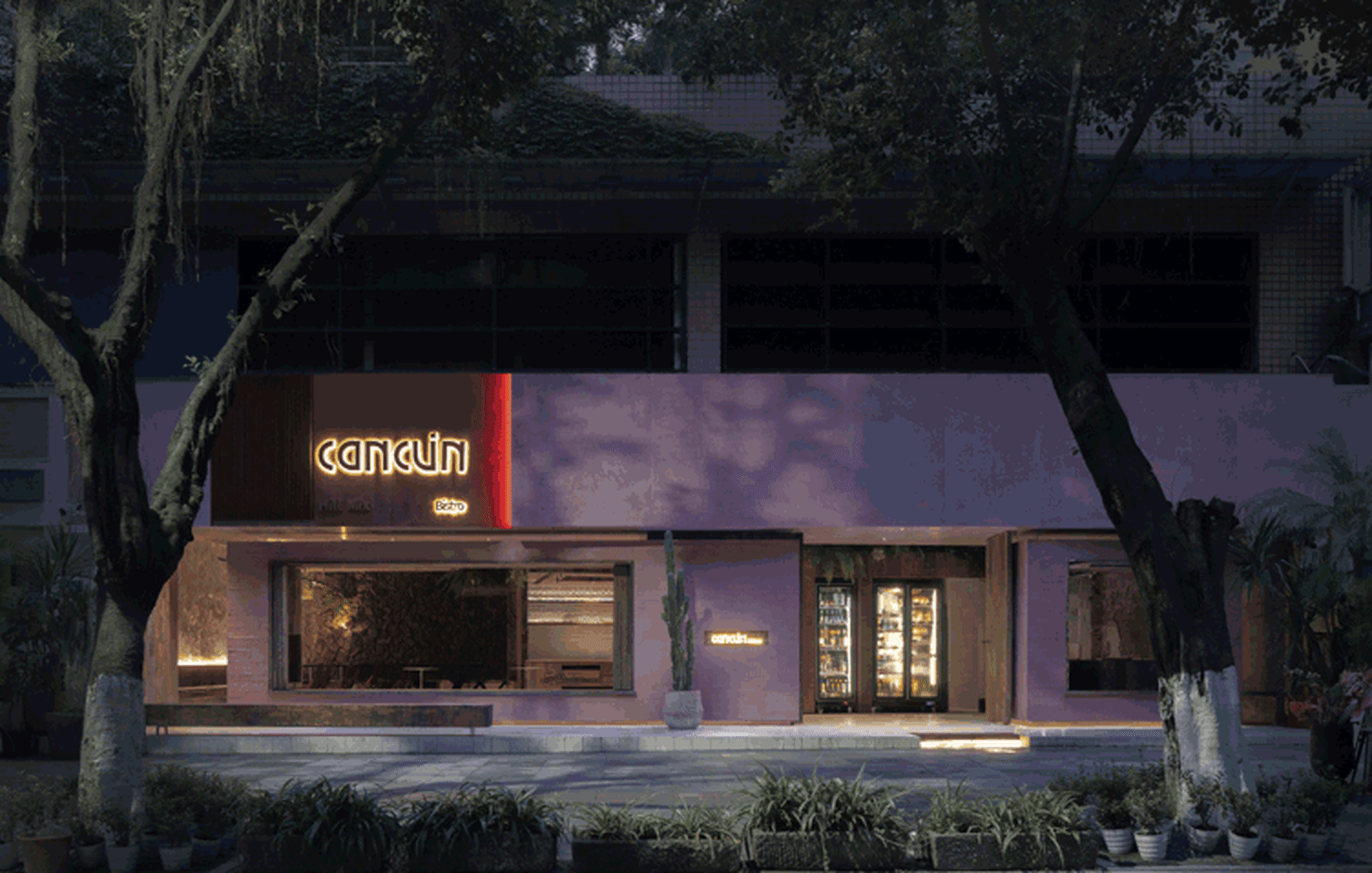 Pink brick storefront with large glass windows and signage.