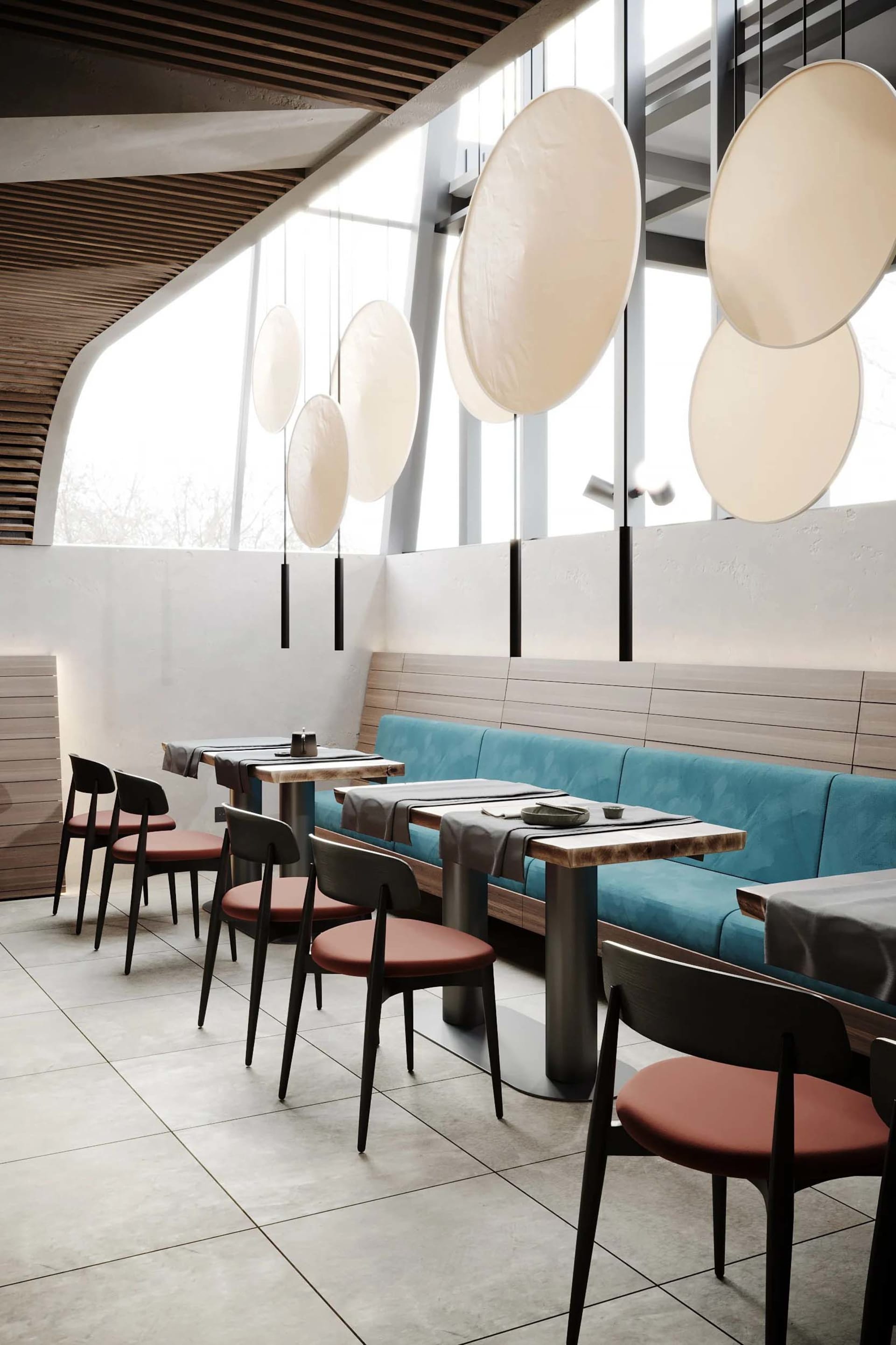 A modern cafe with a sleek design featuring minimalist furniture, concrete tiles, and large windows for natural light.