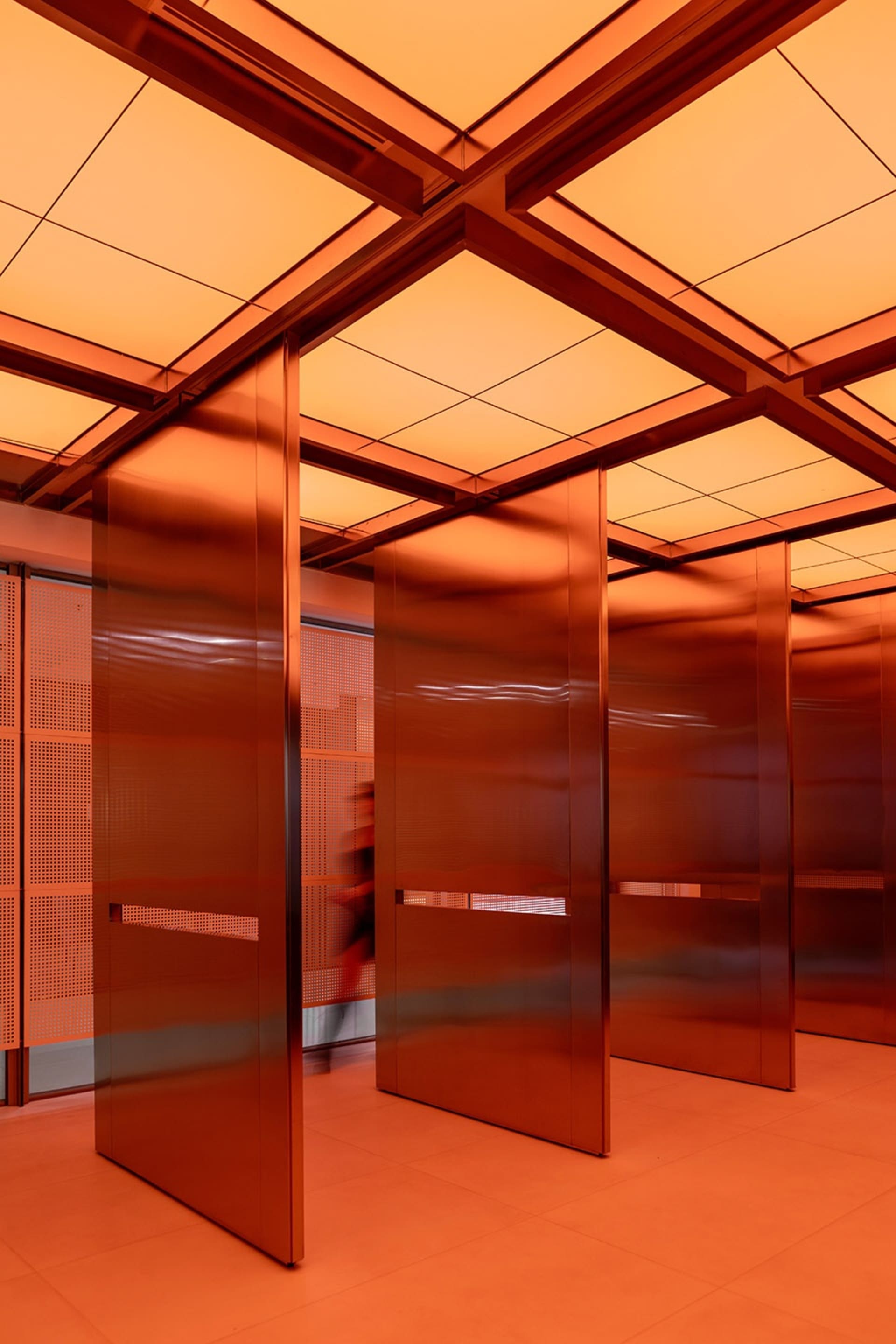 Modern interior with metallic walls and glass panels
