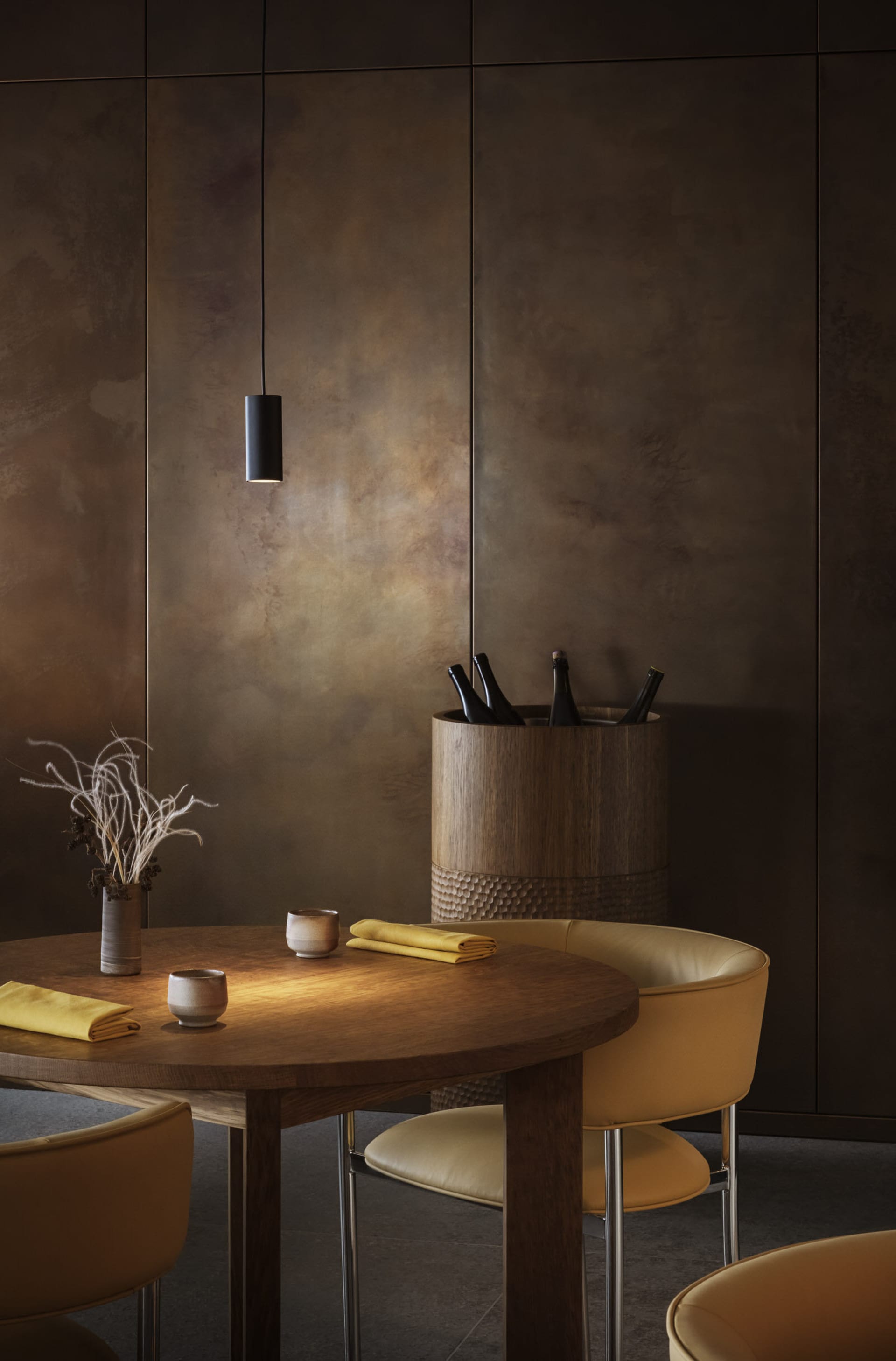 A stylish, modern dining room with wooden table, leather chairs, and rustic decor elements.