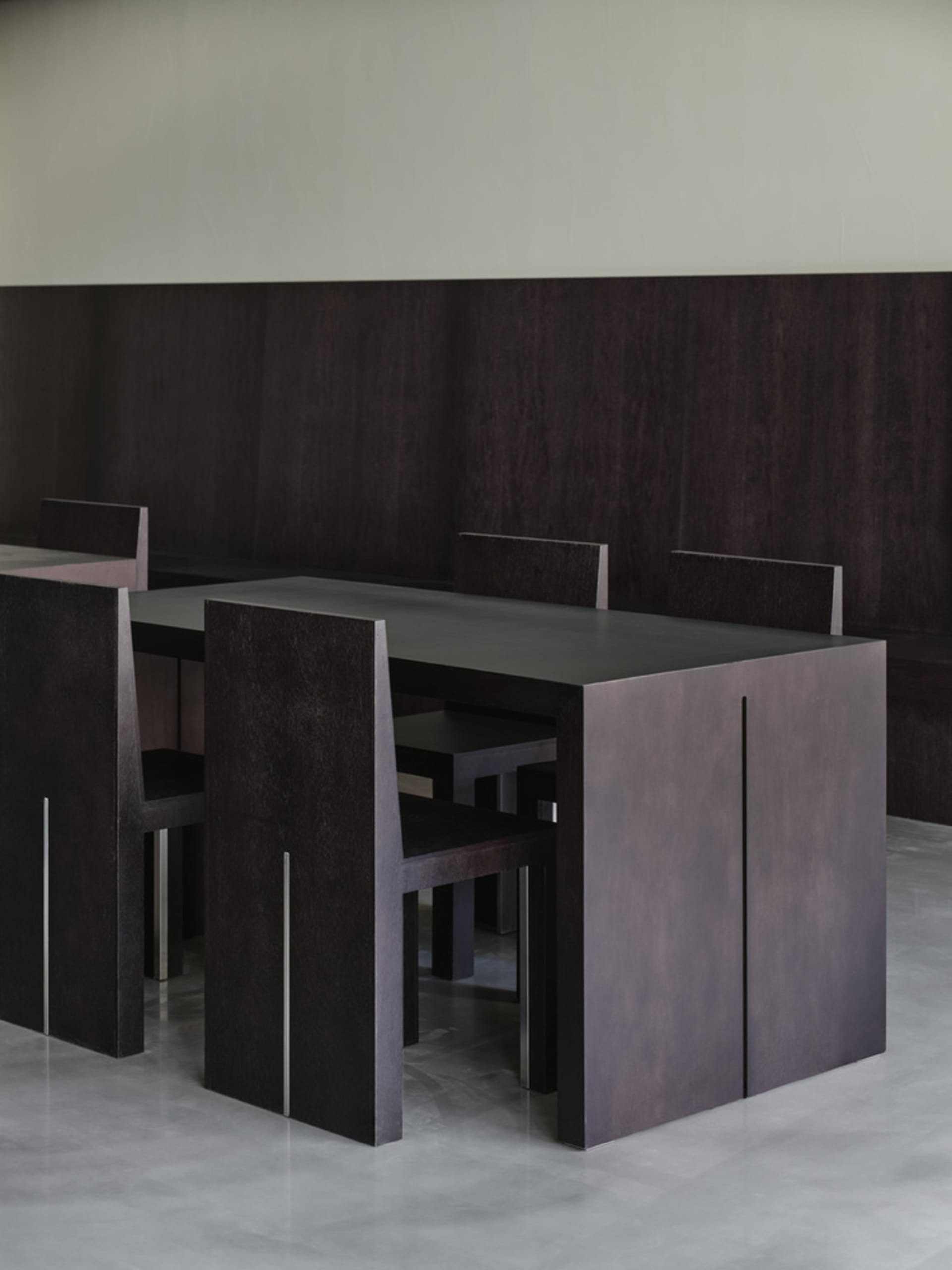 A modern dining room with dark wooden tables and chairs, modern design furniture, minimalist interior design, dark wooden flo