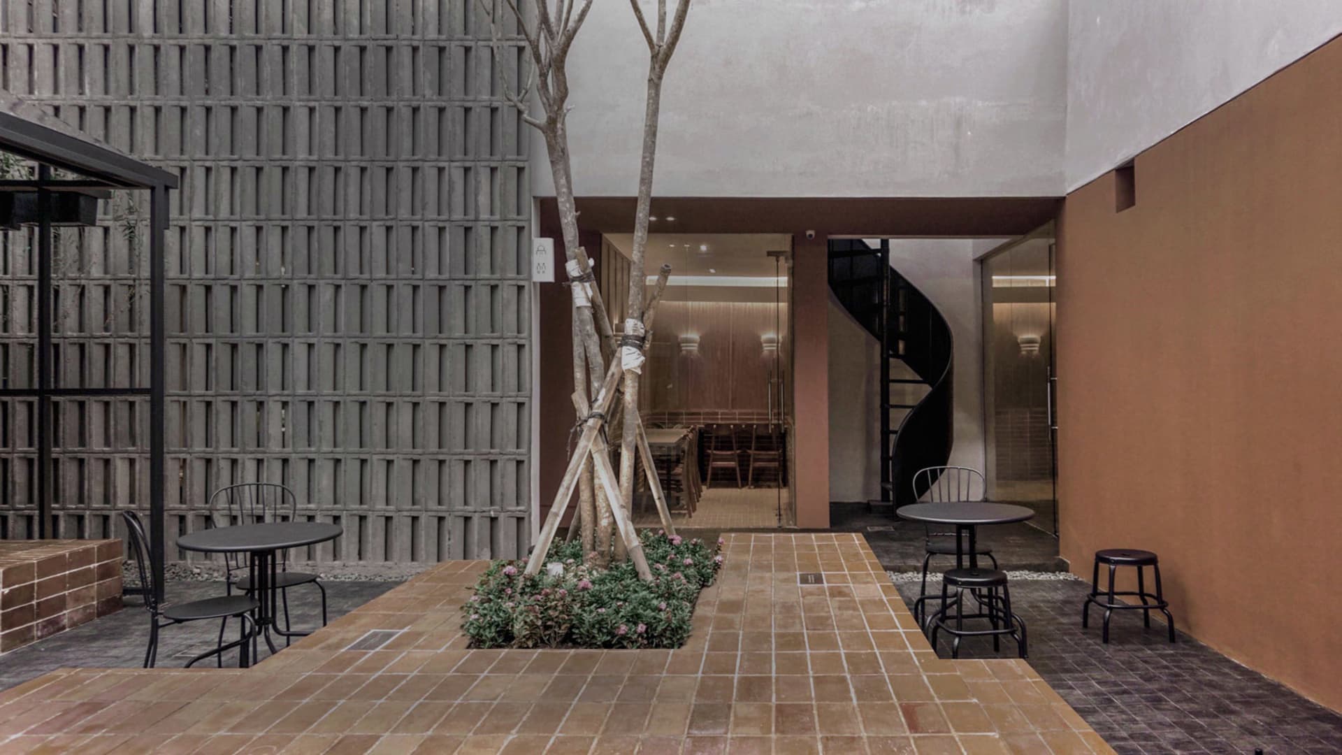 Modern industrial restaurant interior with concrete and minimalist features.