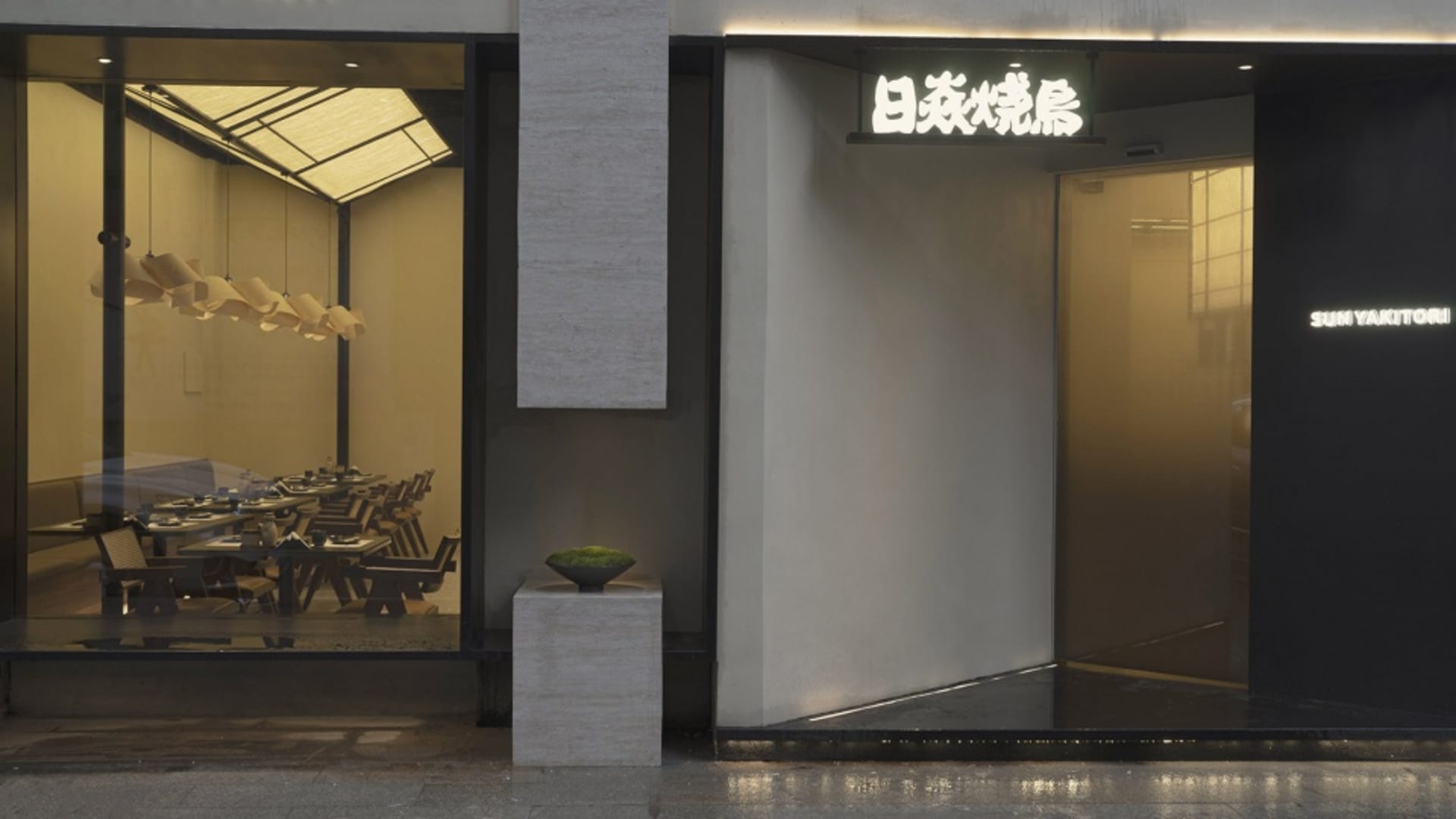 A modern minimalist restaurant exterior with sleek materials and clean lines.