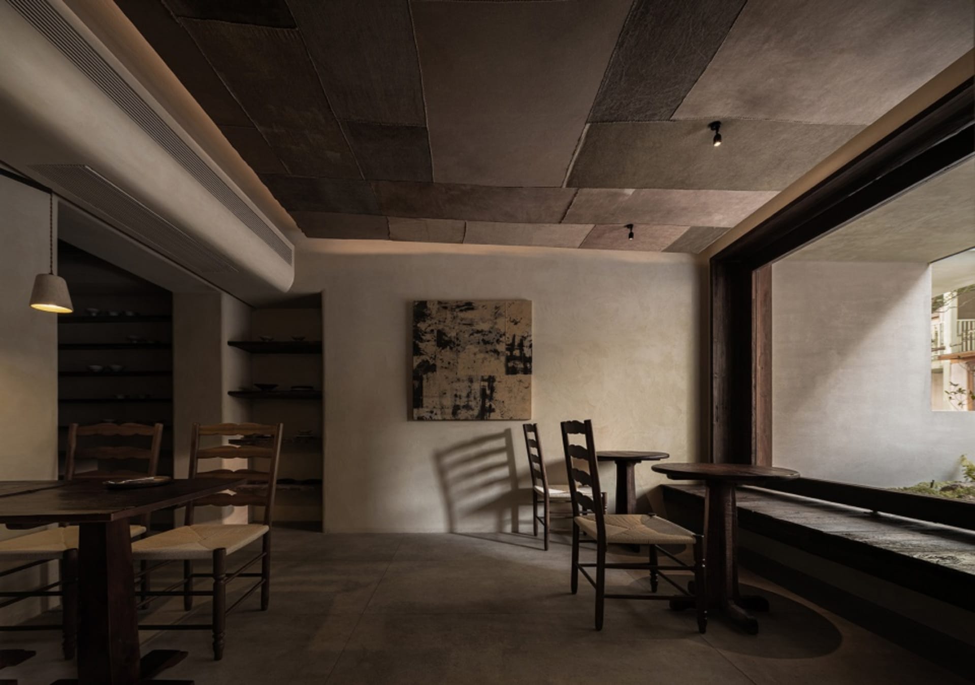 Industrial-style restaurant interior featuring concrete walls and wooden furniture
