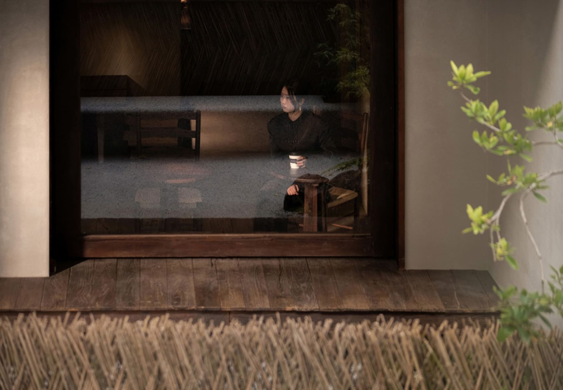 A traditional Japanese living room with wooden floors and a bamboo fence.