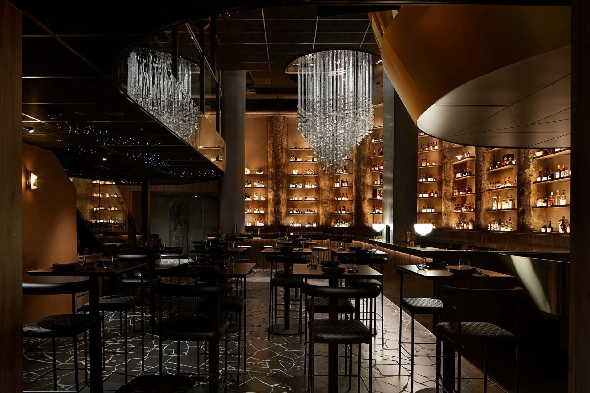 An industrial-style restaurant interior with metallic accents and modern lighting.