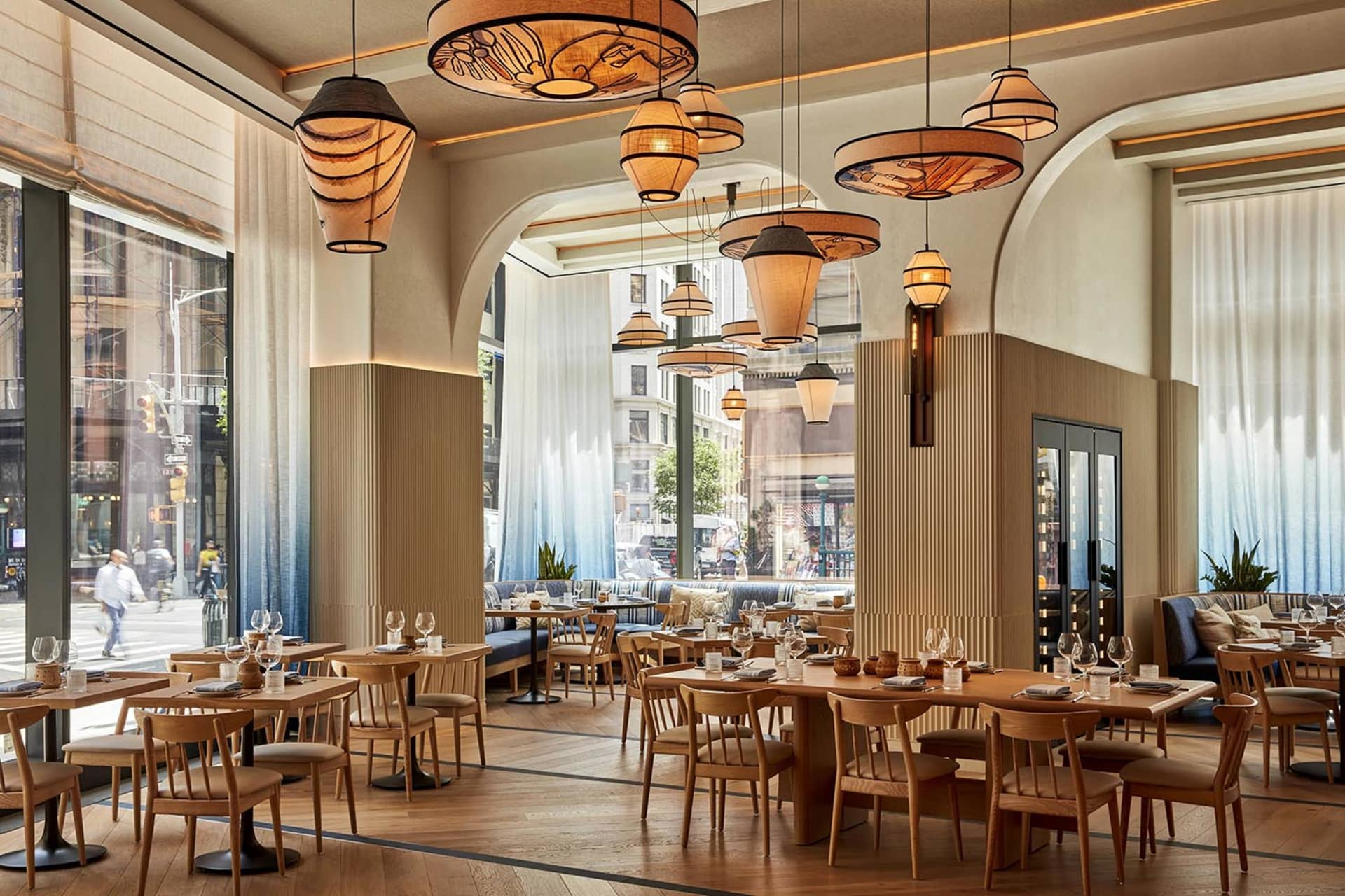 Industrial-themed restaurant interior with wooden tables and chairs.
