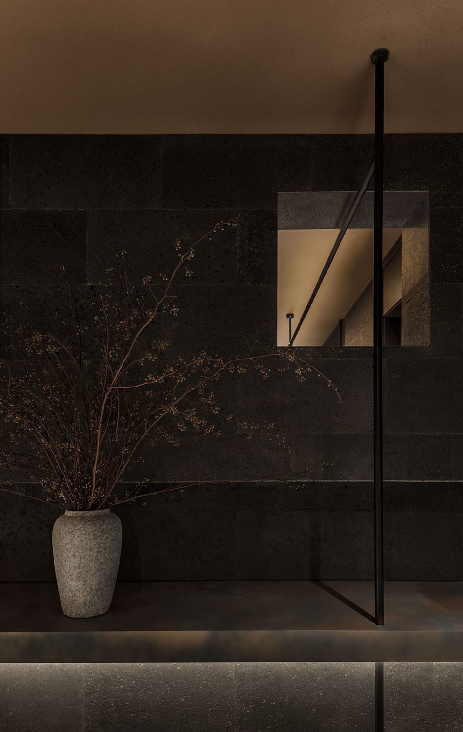Contemporary minimalist interior design featuring a sleek, modern concrete table lamp with a minimalist aesthetic on a simple