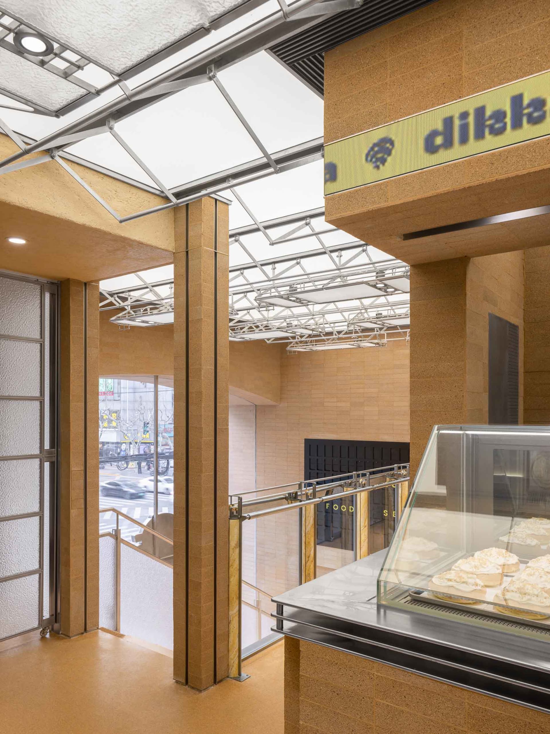 Modern retail storefront with concrete walls and a glass storefront window.