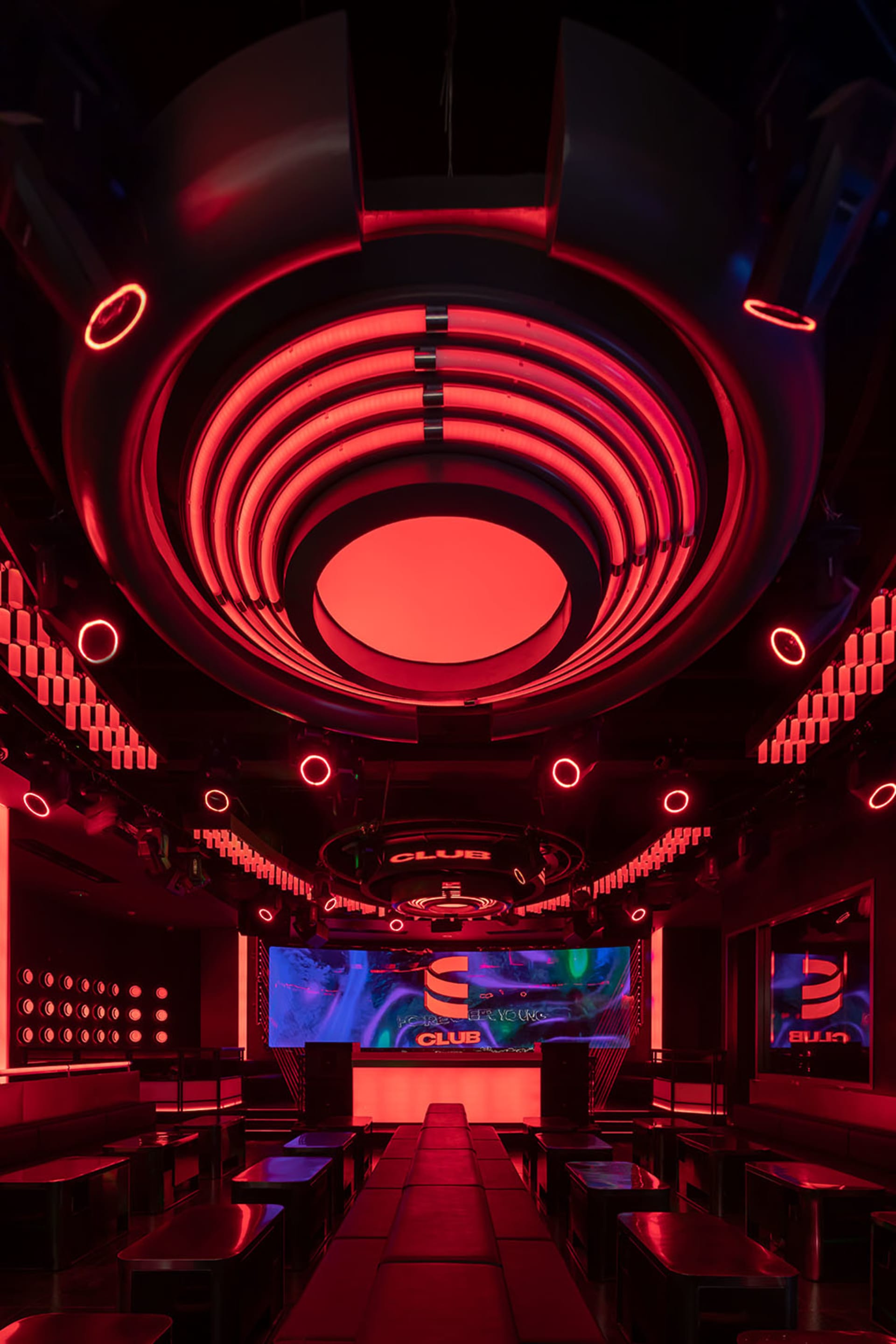 Interior design of a modern nightclub with neon lighting.