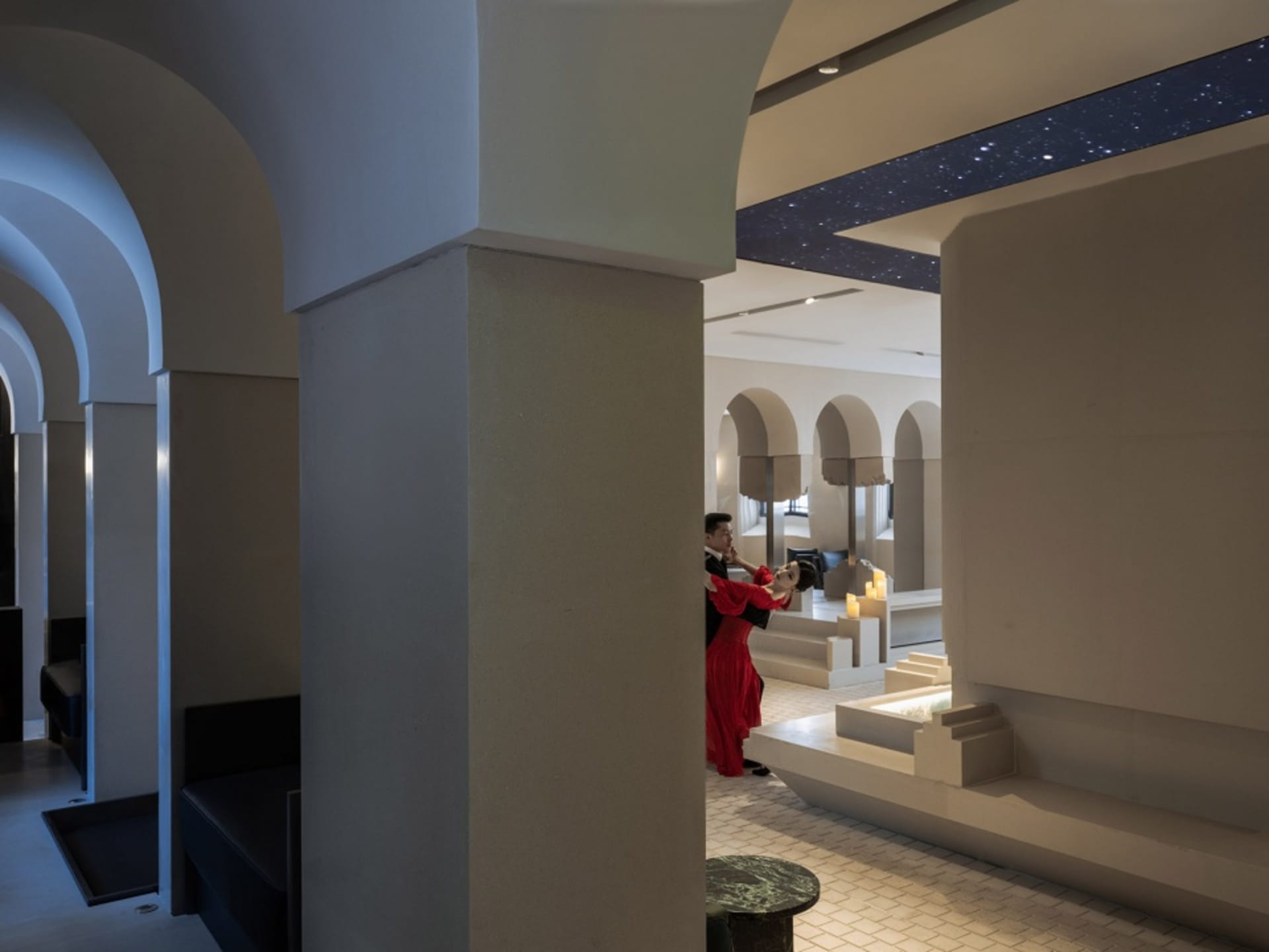 A contemporary interior space featuring concrete elements and minimalist design.