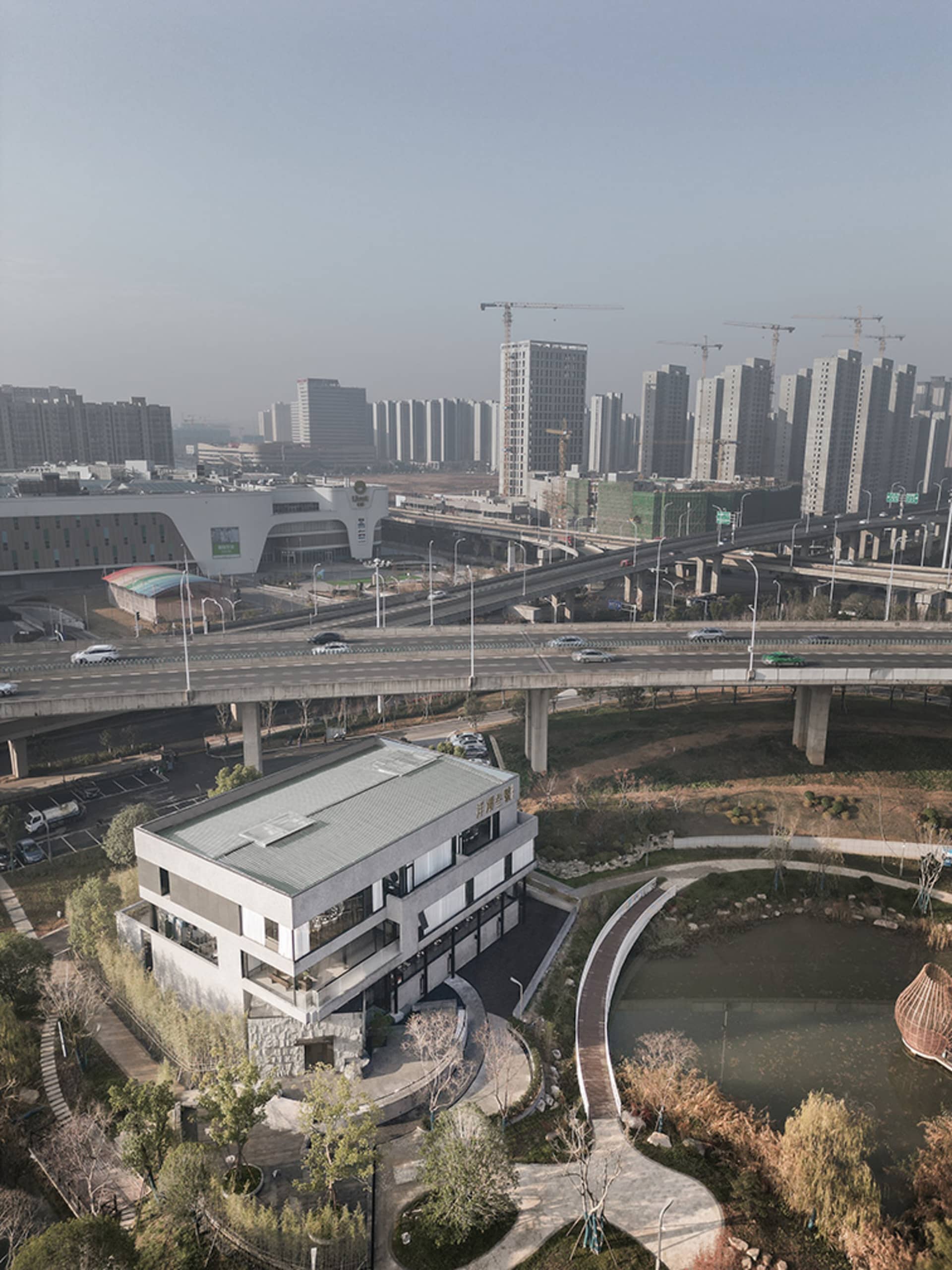 A minimalist urban landscape featuring concrete structures and greenery.