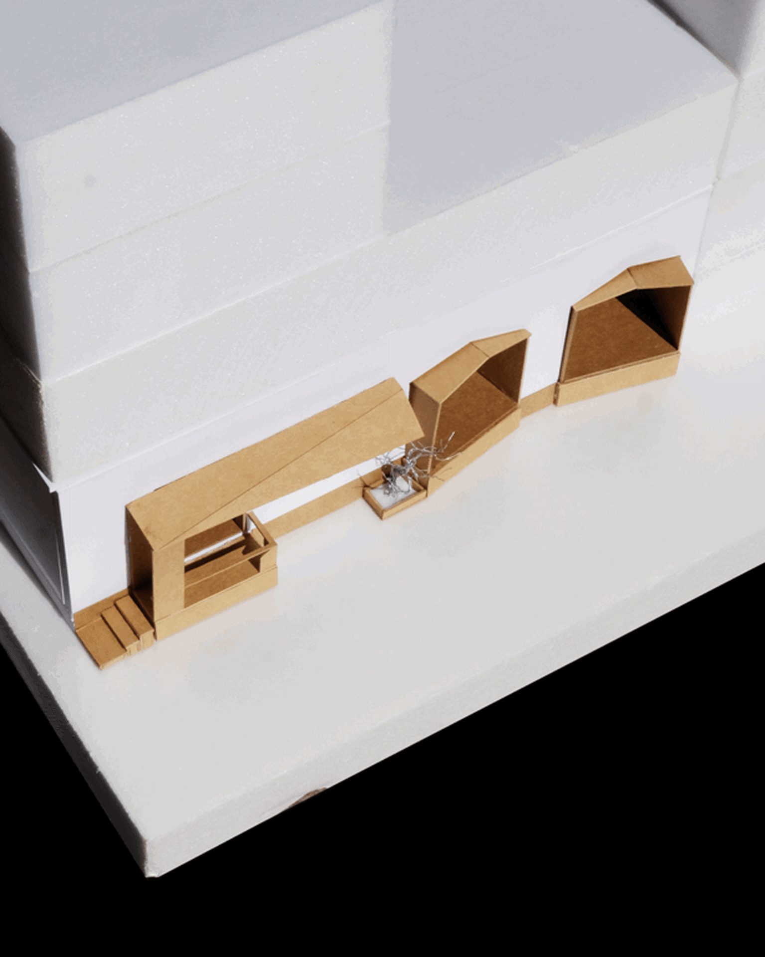 A detailed architectural model created from cardboard depicting an interior design.