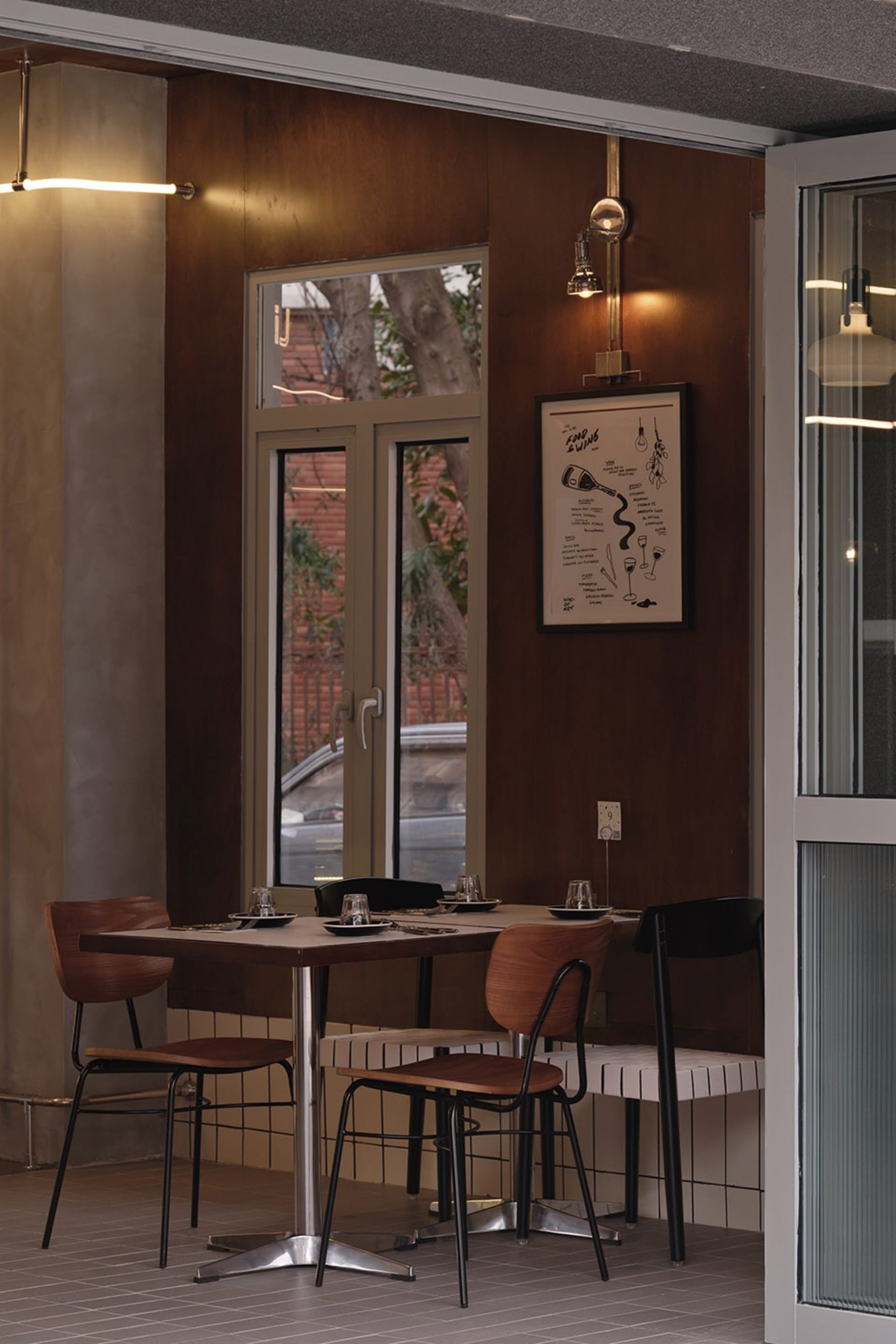 Industrial-style restaurant interior with wood, metal, and glass materials.