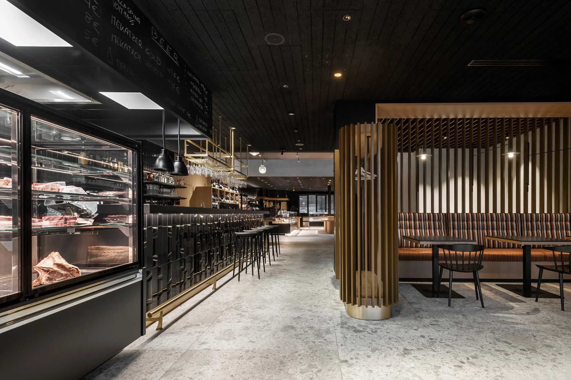 Industrial-style restaurant interior with black metal and wood finishes.