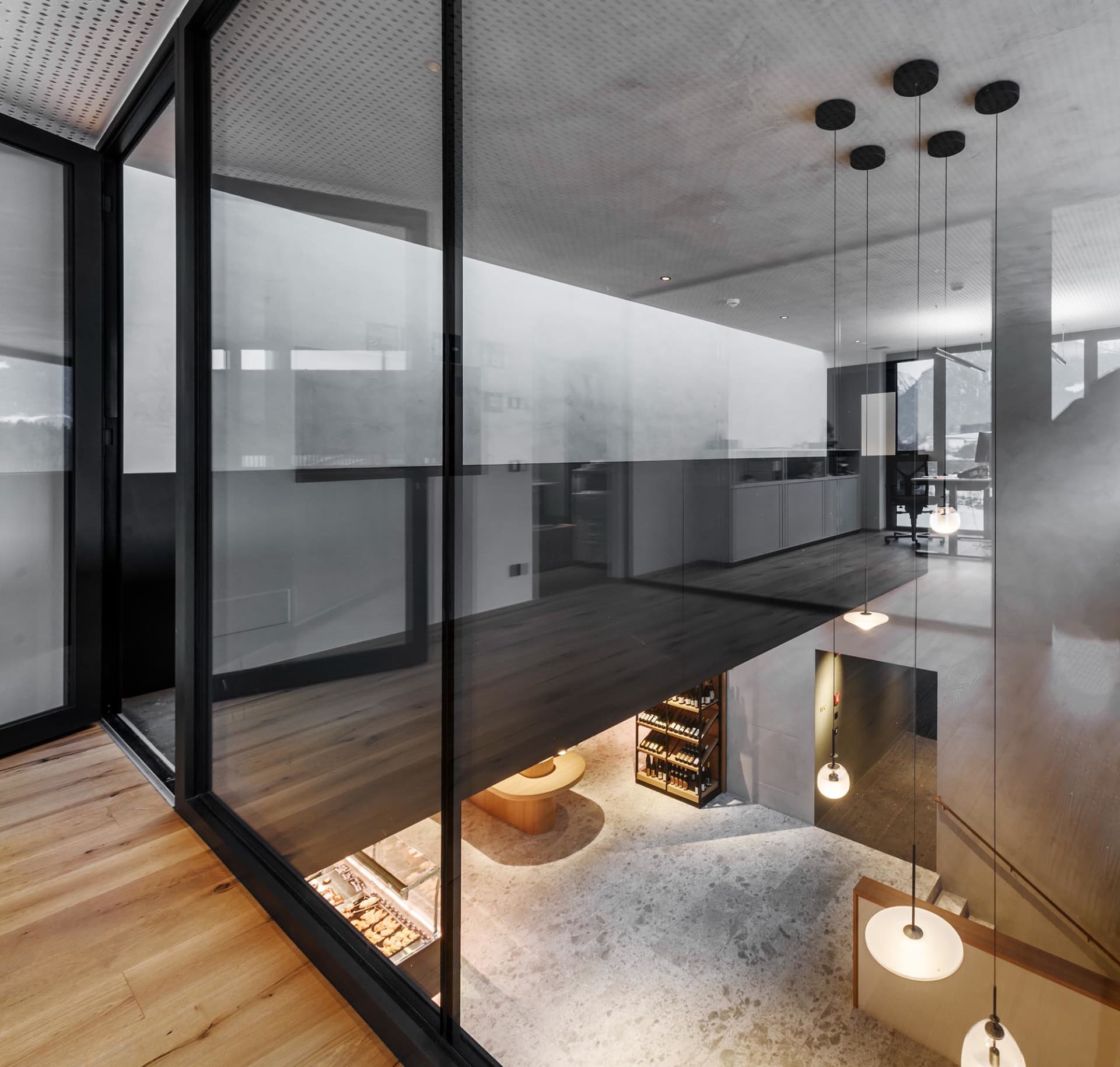 A modern retail space featuring concrete walls, wooden accents, and glass elements.