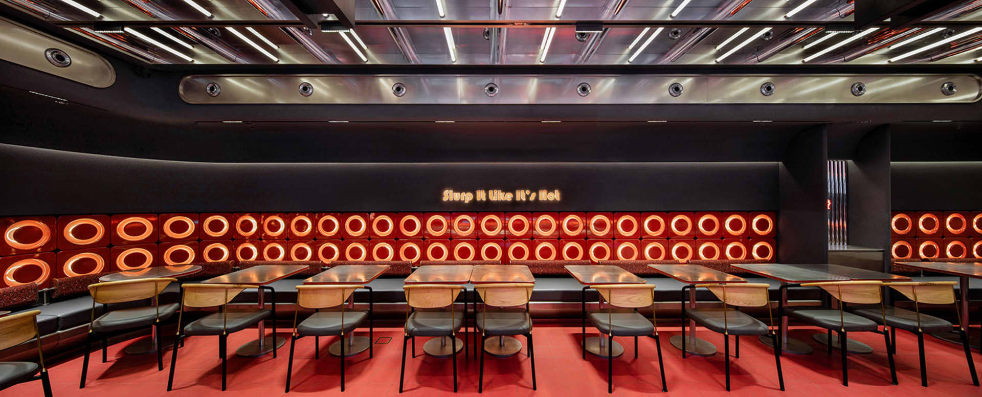 A spacious restaurant interior featuring a metallic inlay design