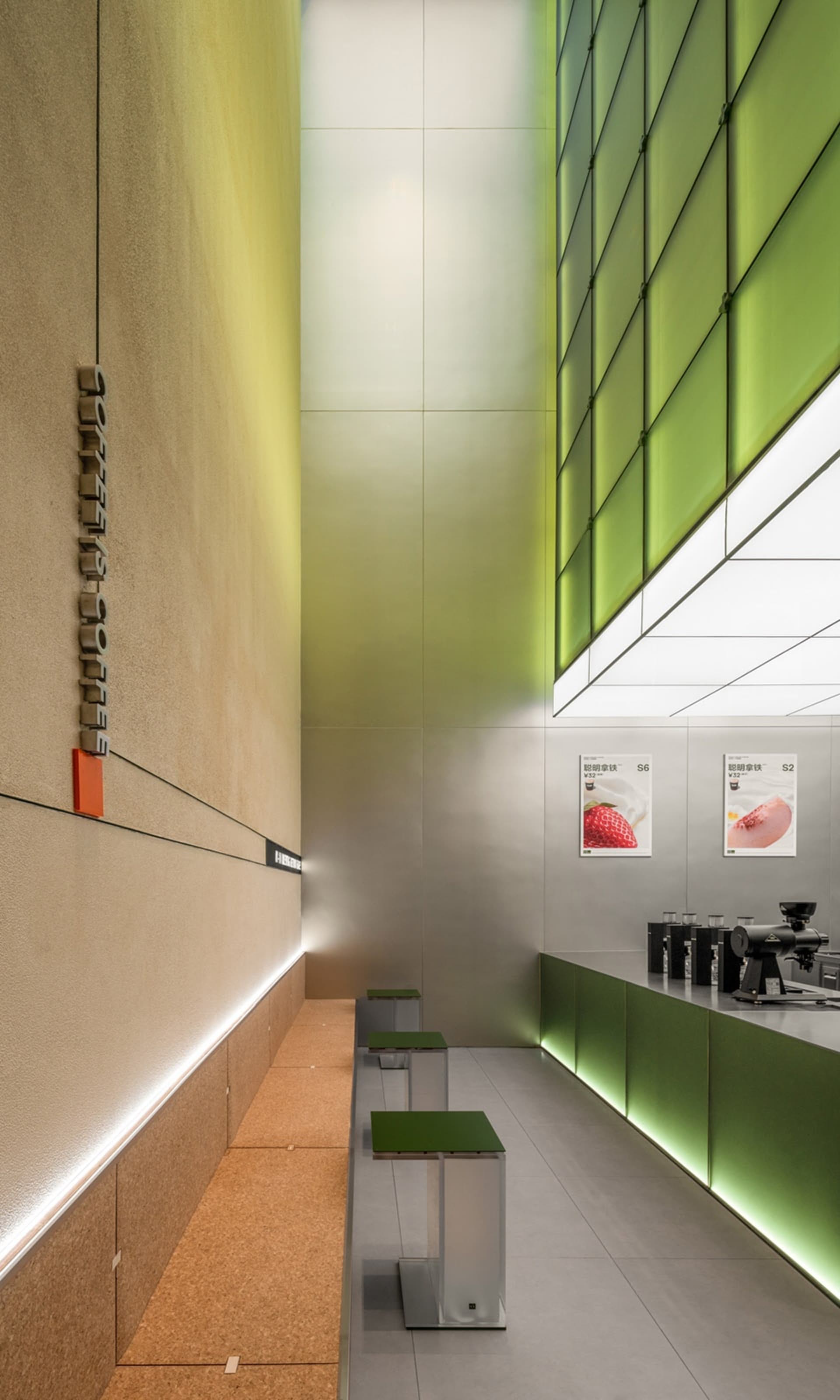 Modern coffee shop interior with green glass walls and LED lighting.