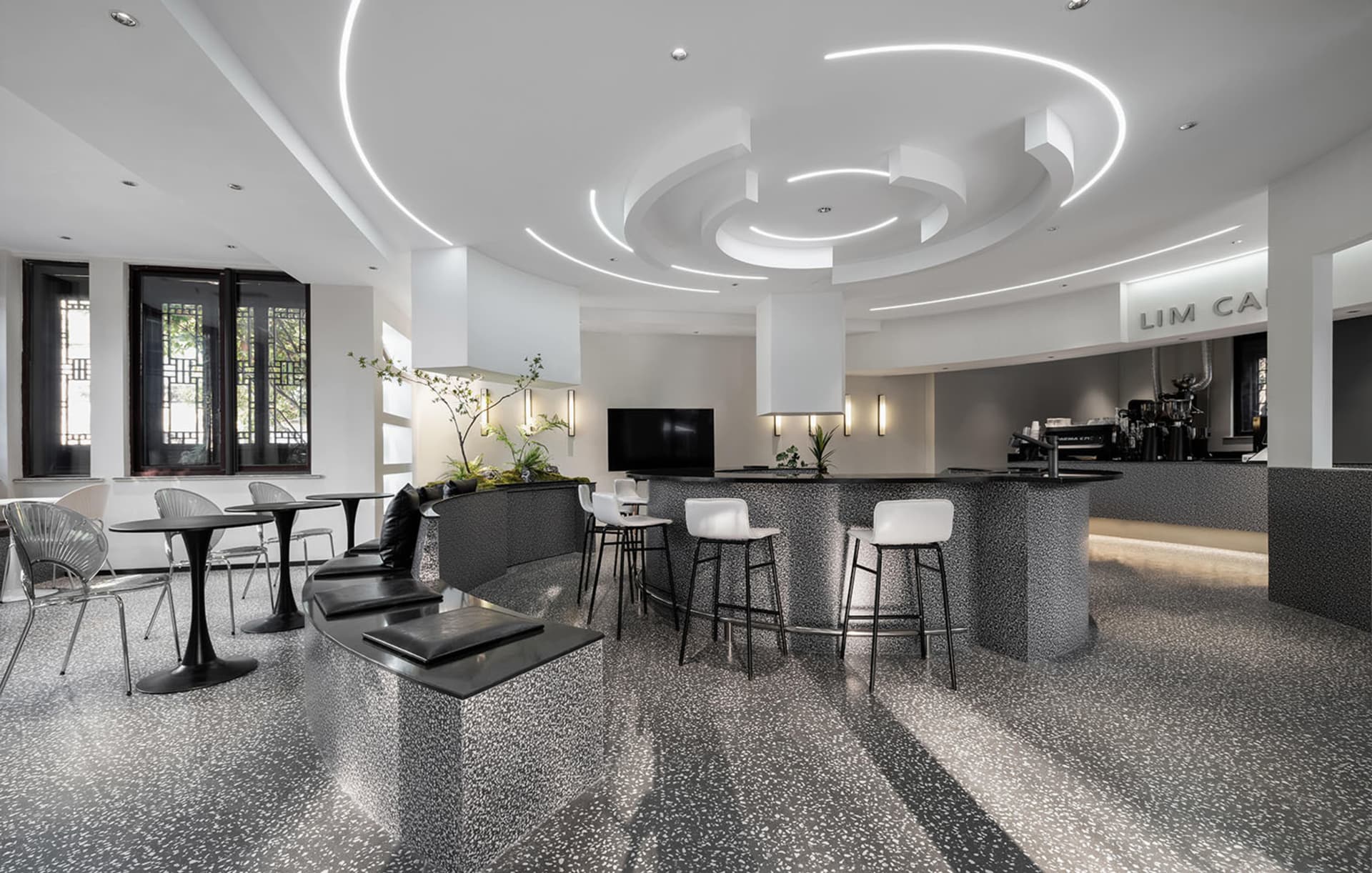Modern coffee shop interior featuring minimalist design with terrazzo flooring.