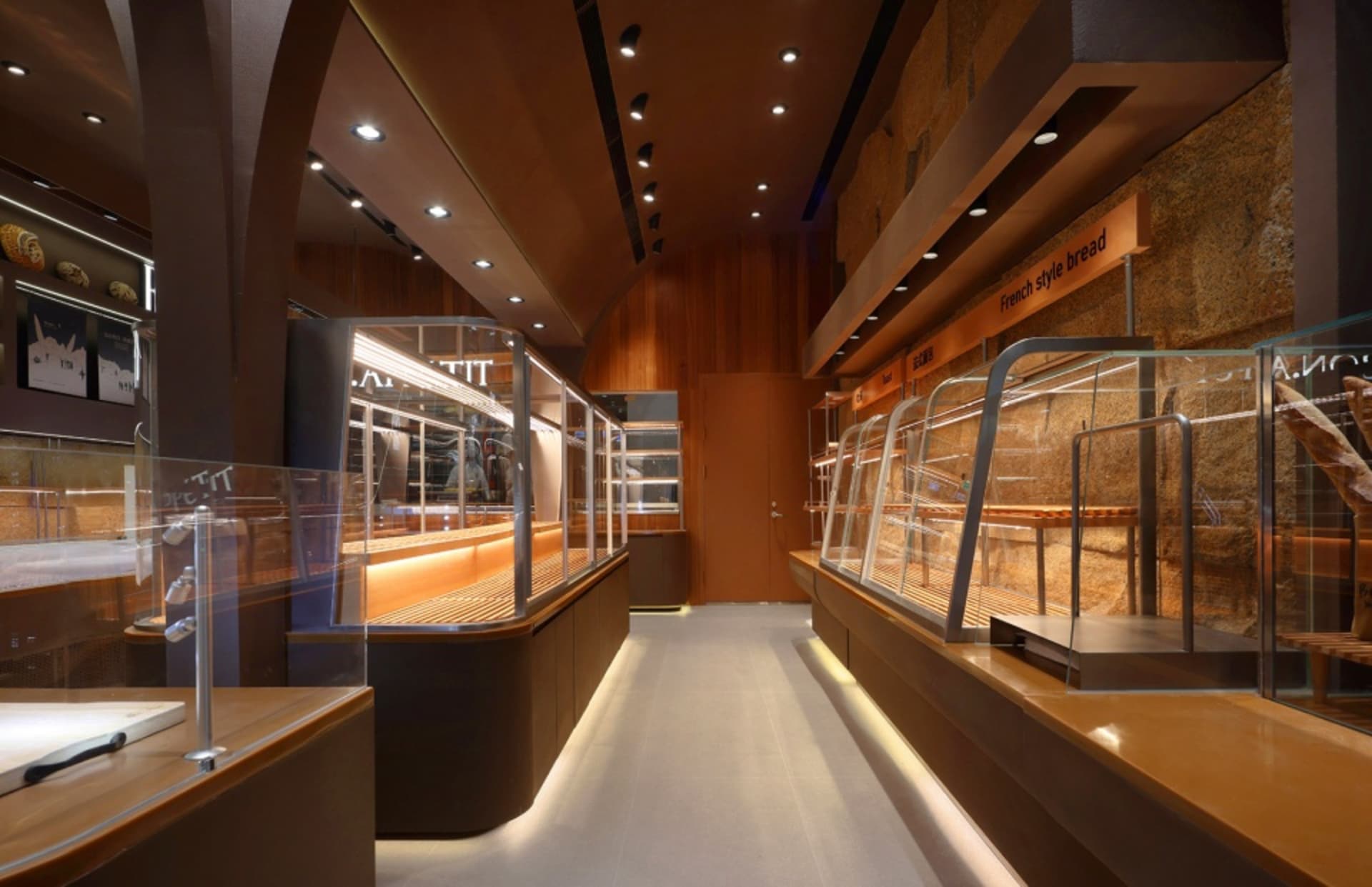 Modern retail store with wooden and glass fixtures and display cases.