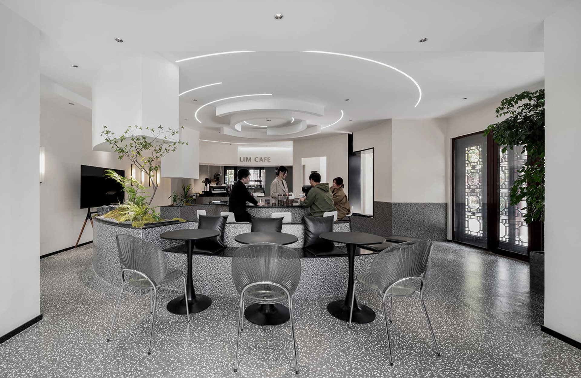 Modern cafe with black and white interior design, featuring sleek furniture and contemporary decor.