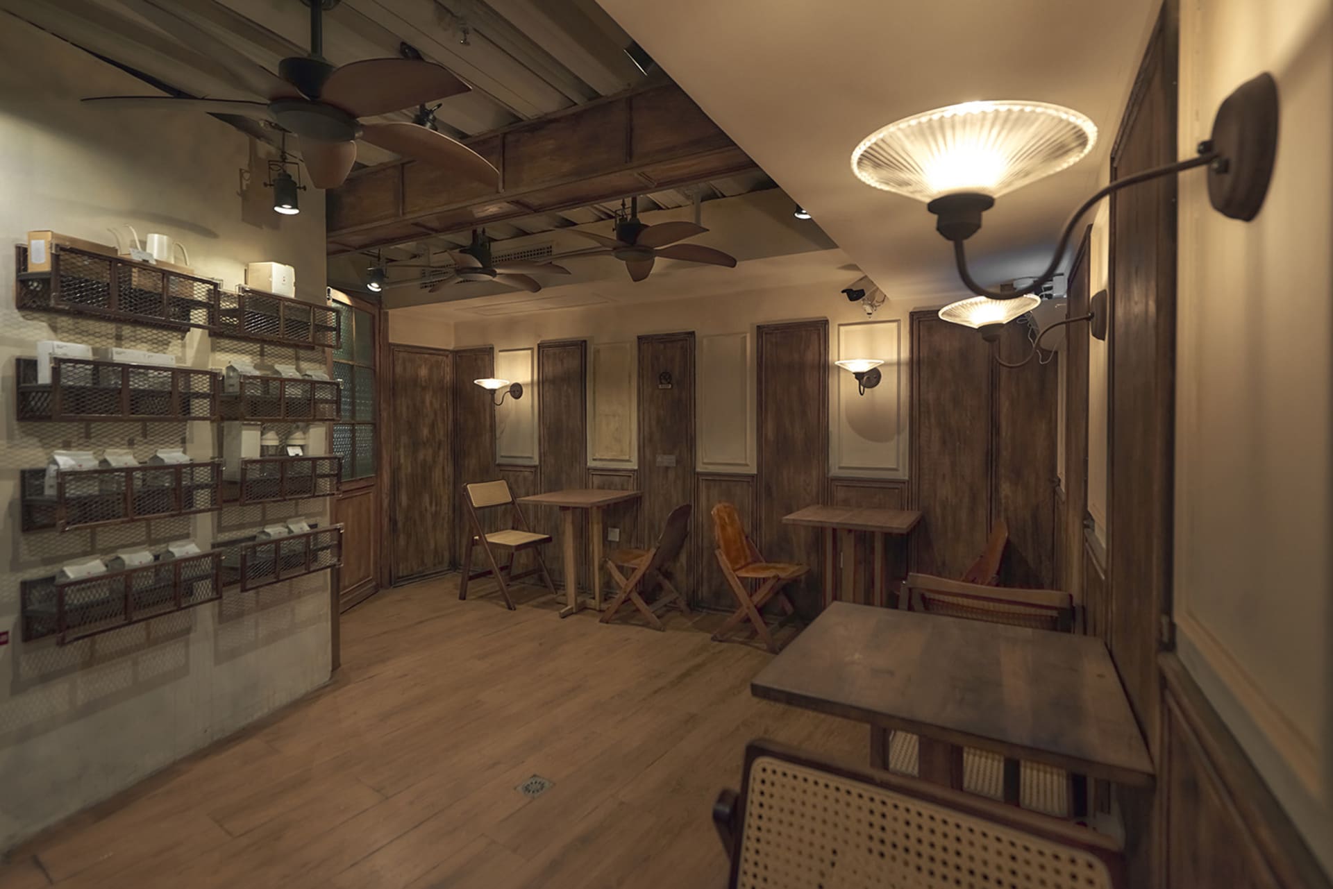 Industrial-themed restaurant interior with wooden furniture and walls.