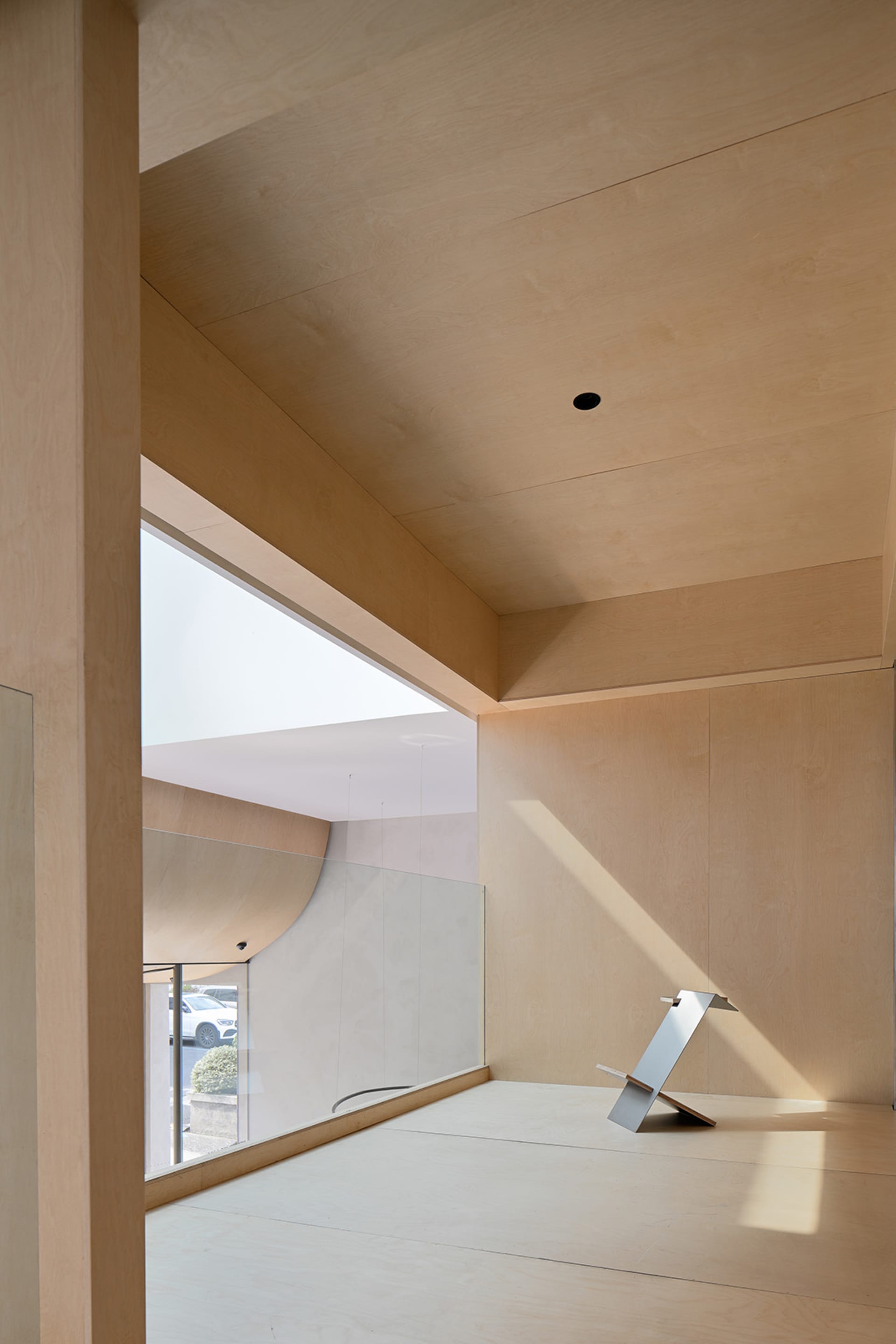 Modern minimalist office with wood-paneled walls.