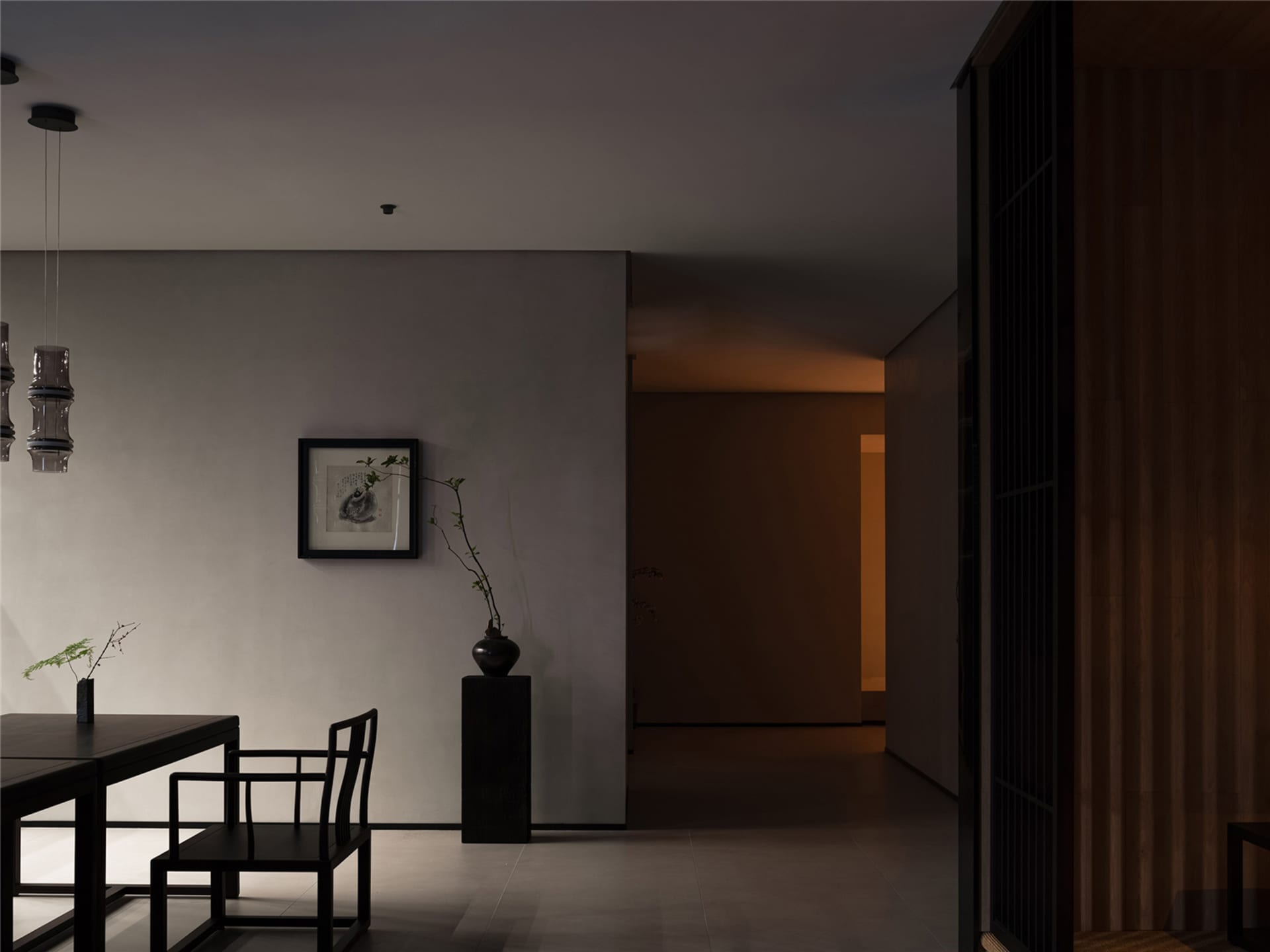 A modern living space featuring concrete flooring and wooden blinds.