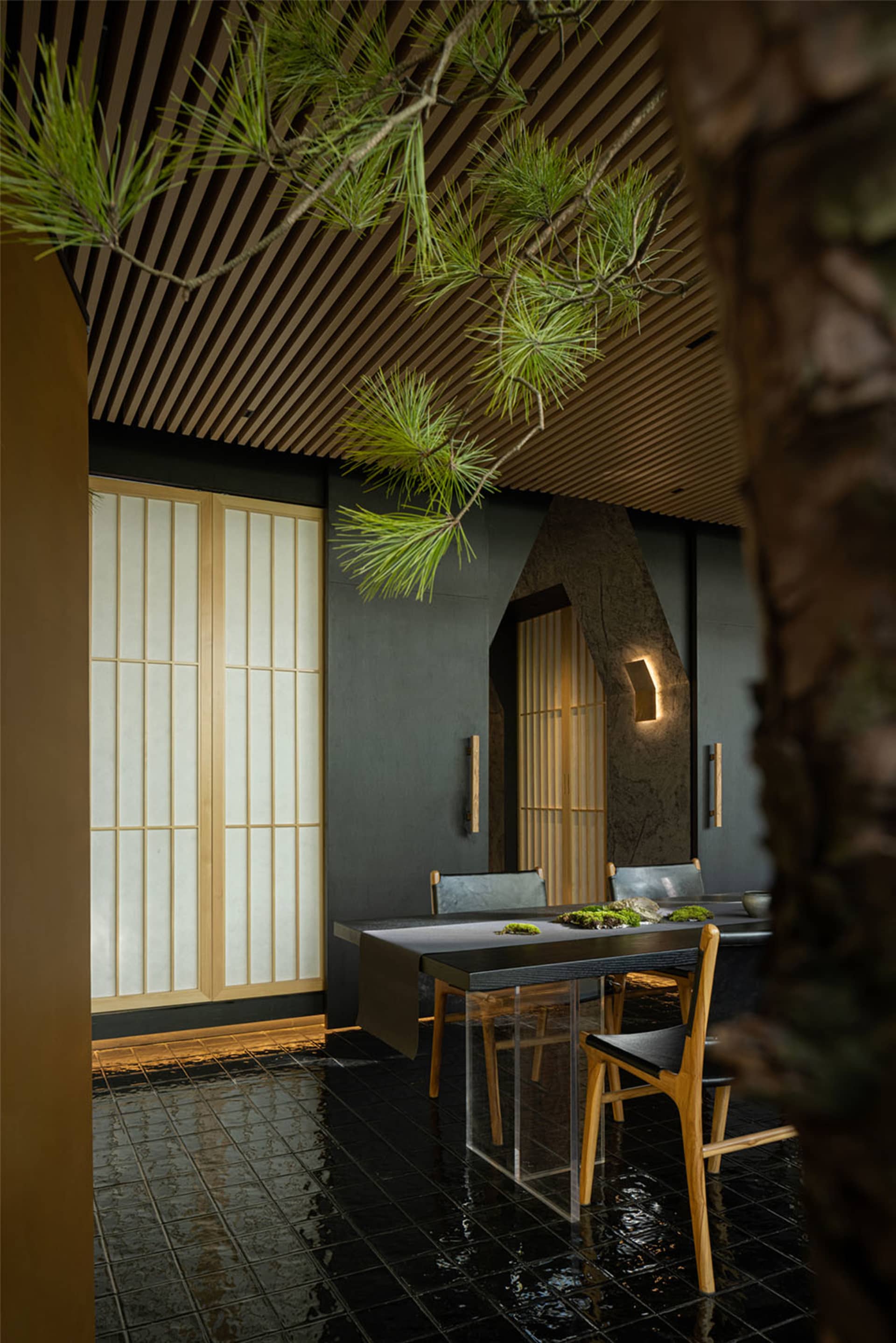 A minimalist restaurant dining room featuring wooden decor and accents.
