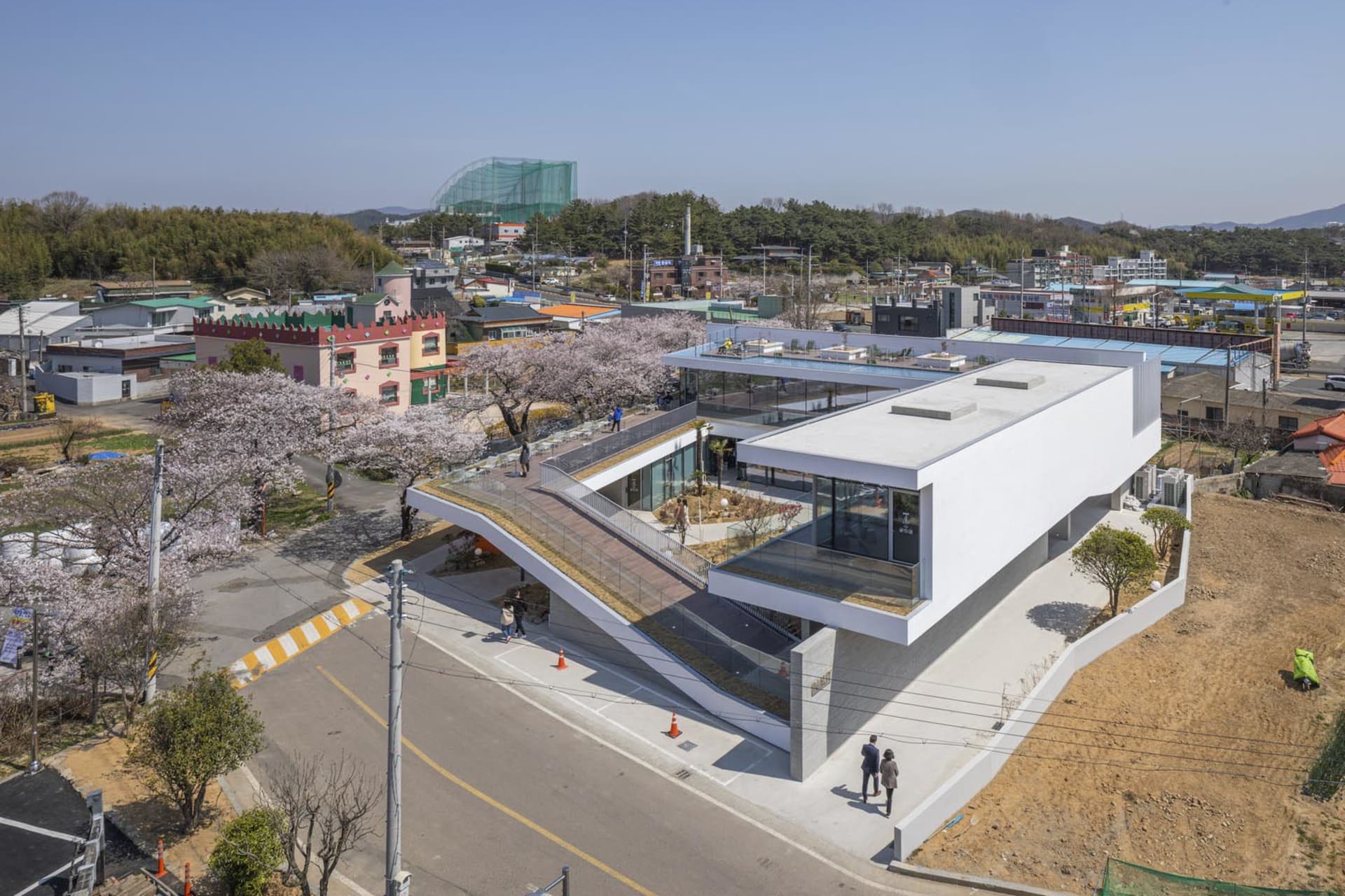 Modern building exterior featuring glass panels and concrete structure