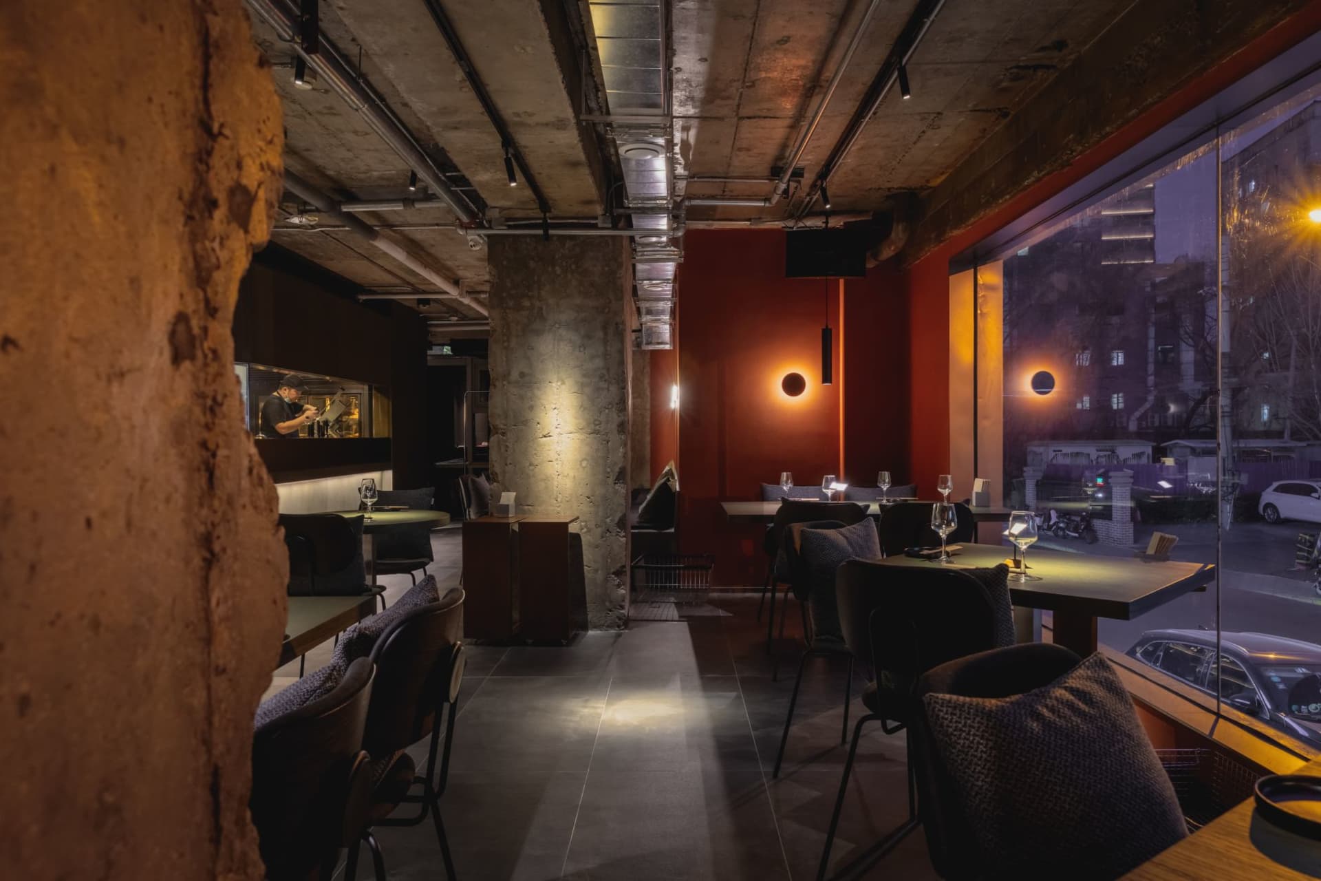 Interior view of a modern restaurant featuring exposed concrete walls and minimalist design.