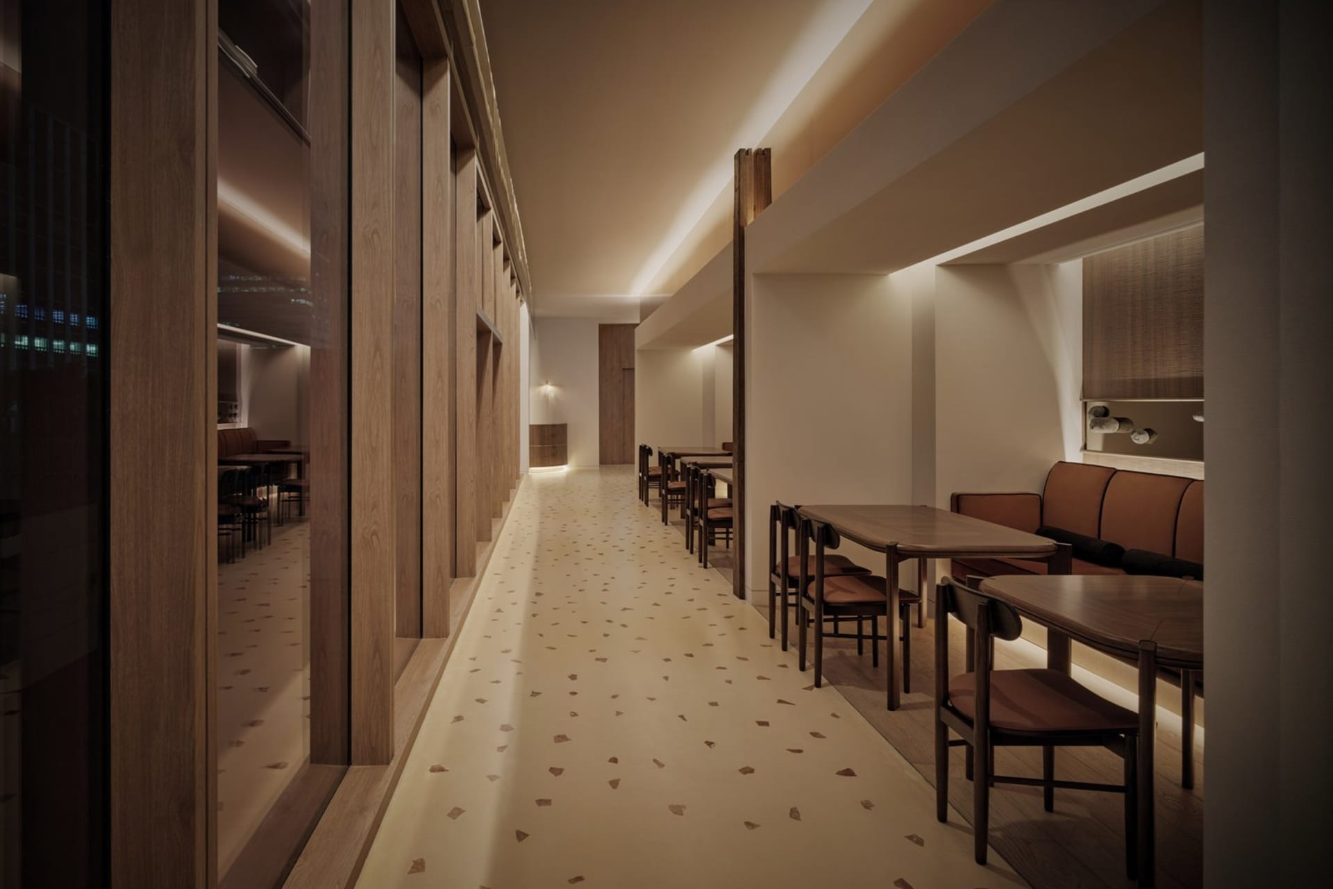 A modern restaurant interior with wooden and leather accents and a warm, inviting atmosphere.