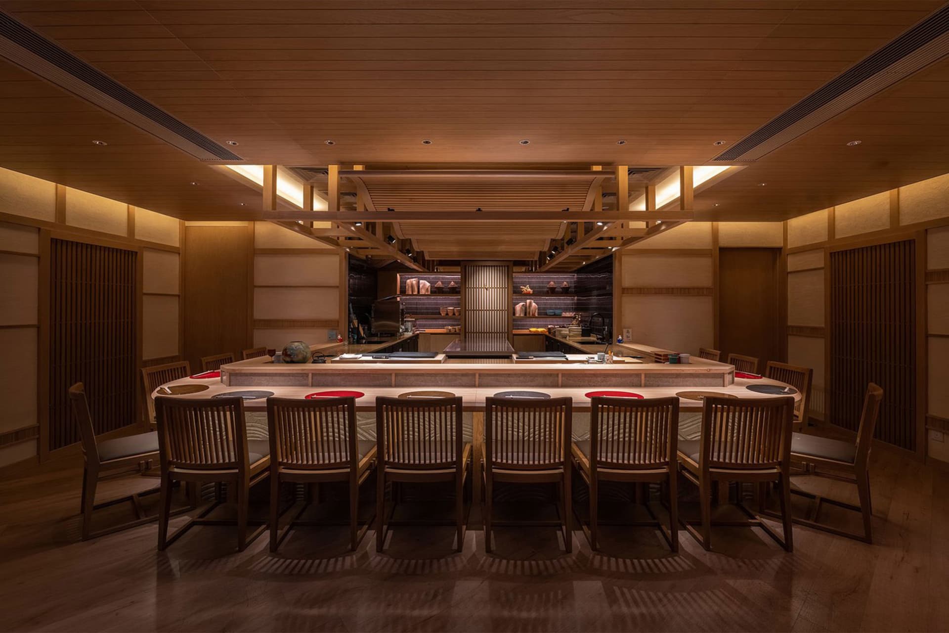 A wooden restaurant interior with a bar area and clean, minimalist design.