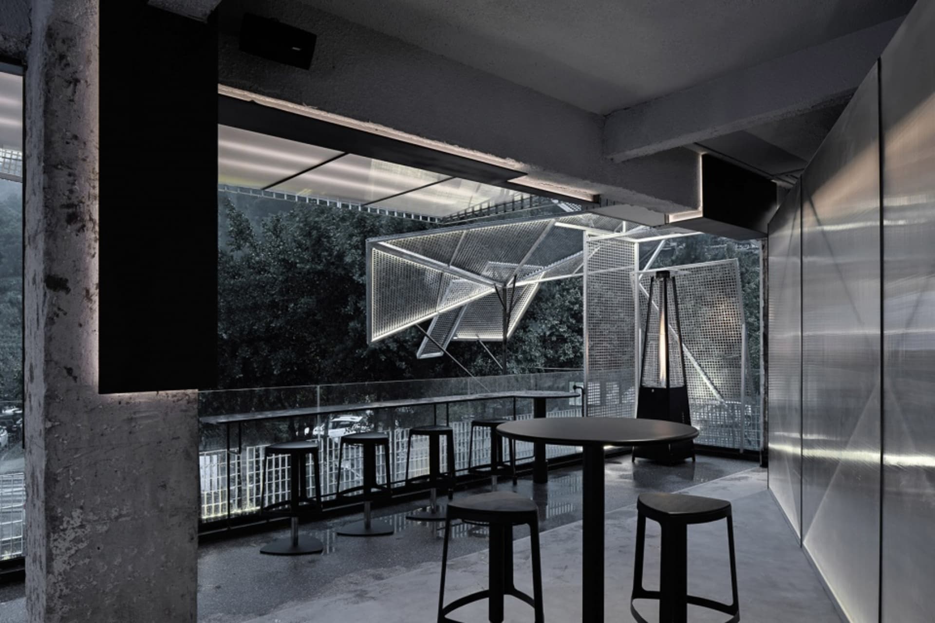 Indoor restaurant with metallic seating and tables, industrial design elements