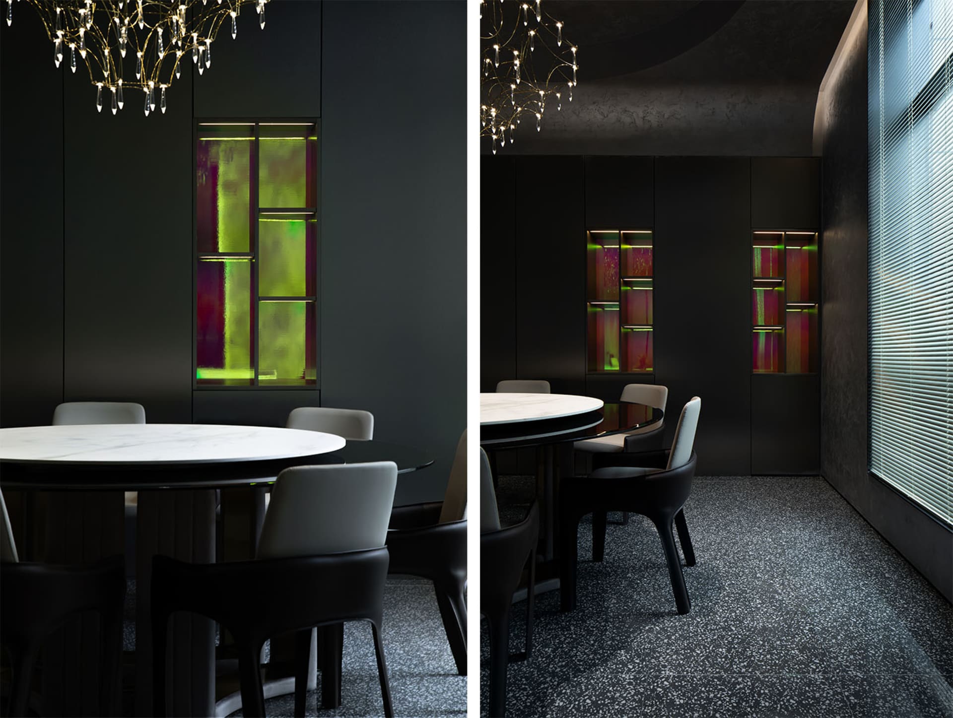 A modern dining room featuring a marble table and chairs, with a glass cabinet displaying colorful artworks.