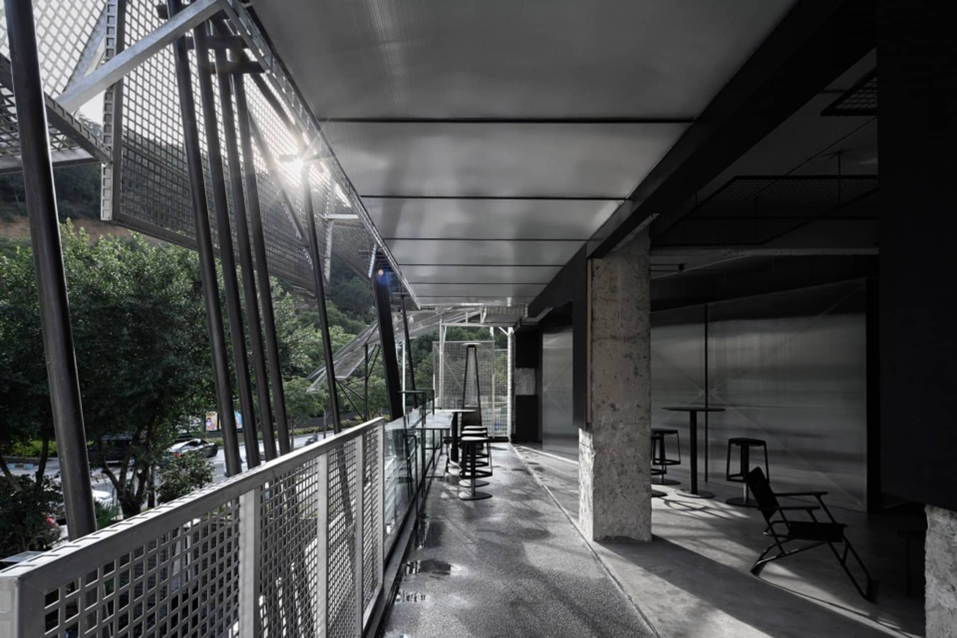 Modern industrial balcony in an airport concourse with metal and concrete retaining walls