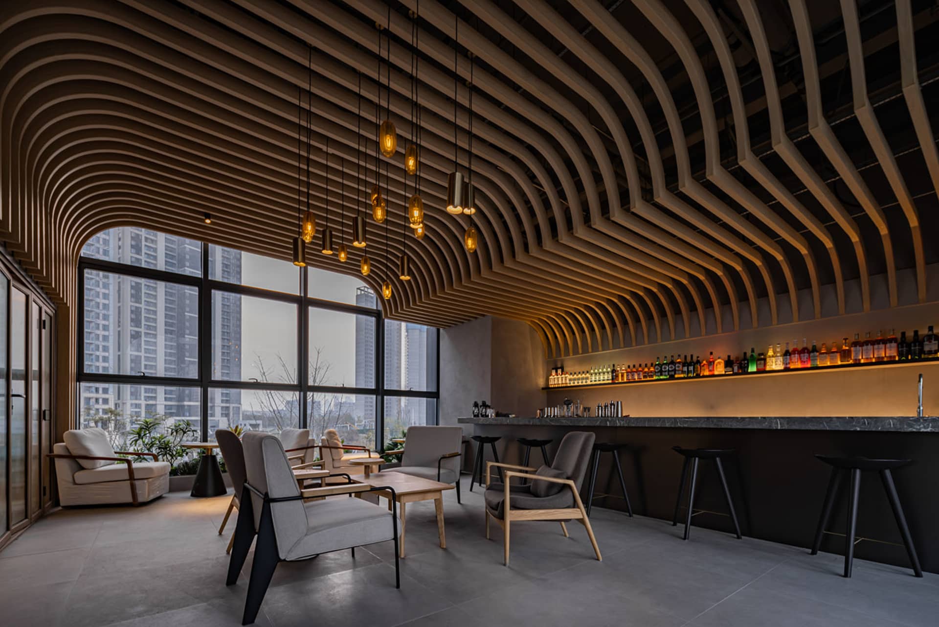 A modern coffee shop bar with wooden elements and concrete flooring, featuring sleek furniture and a well-stocked bar.