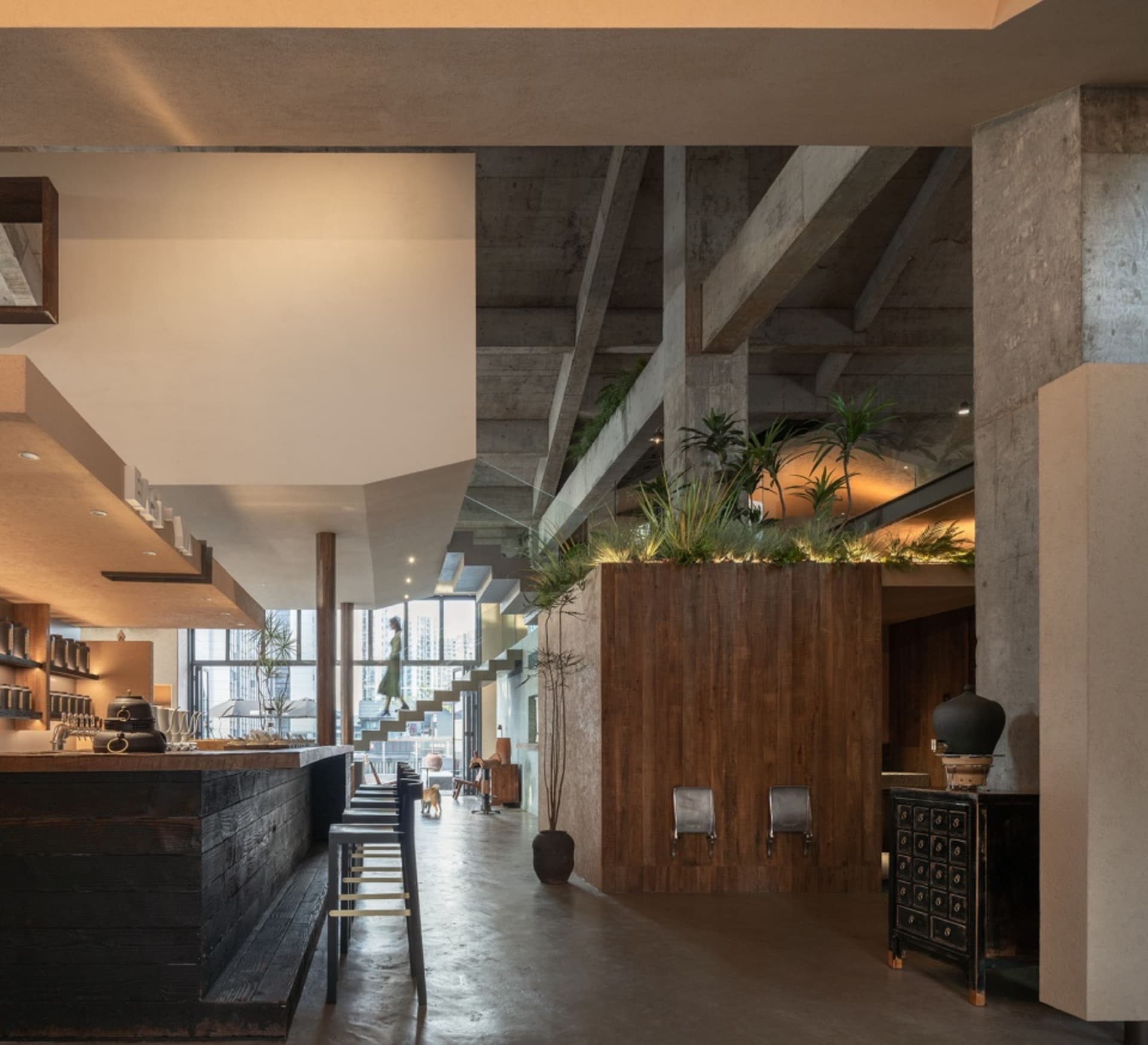 Industrial restaurant interior featuring wood, concrete, and metal materials.