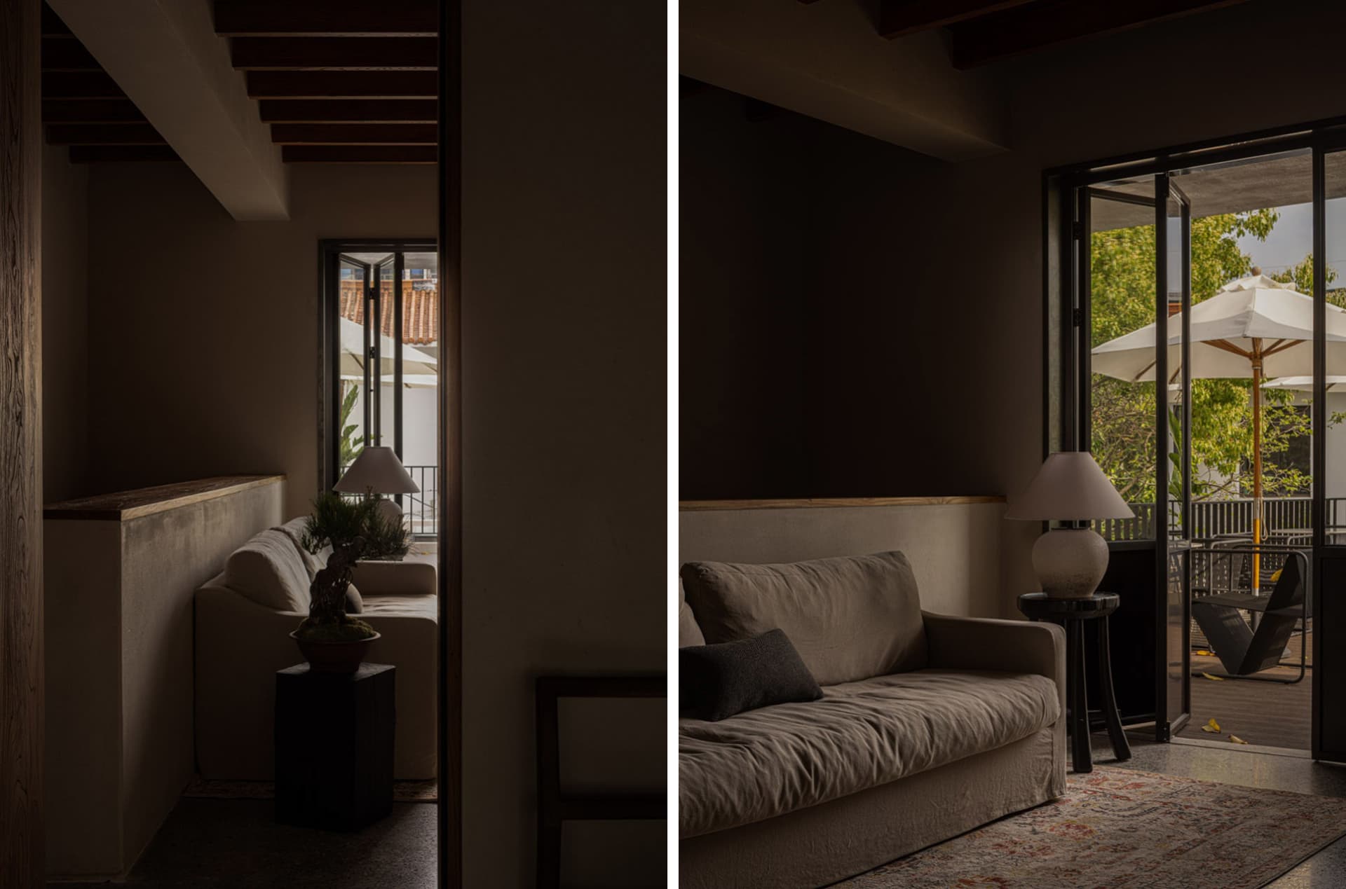 A minimalist living room with concrete walls and a large window.
