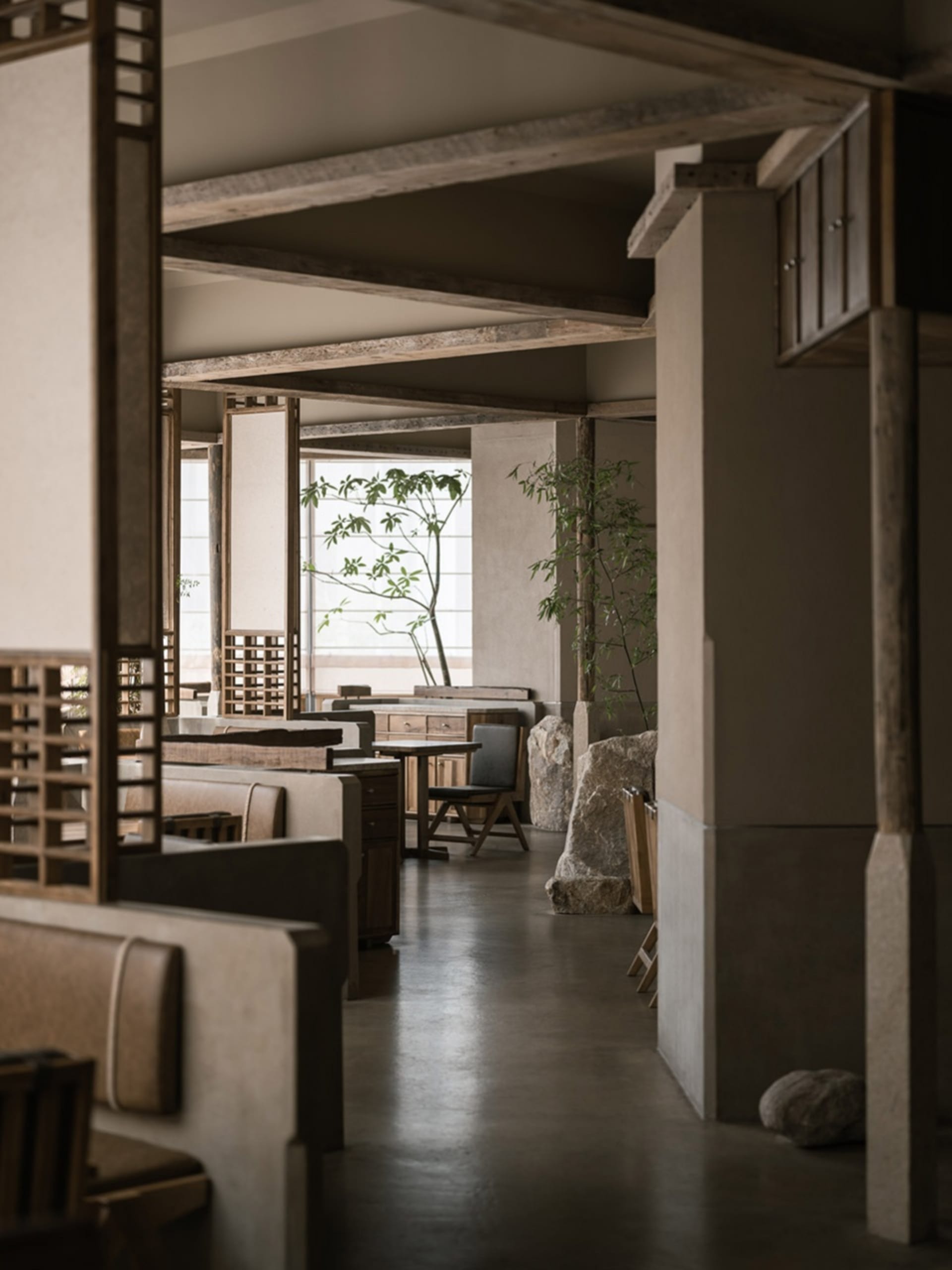 Modern restaurant interior with concrete and wood materials.