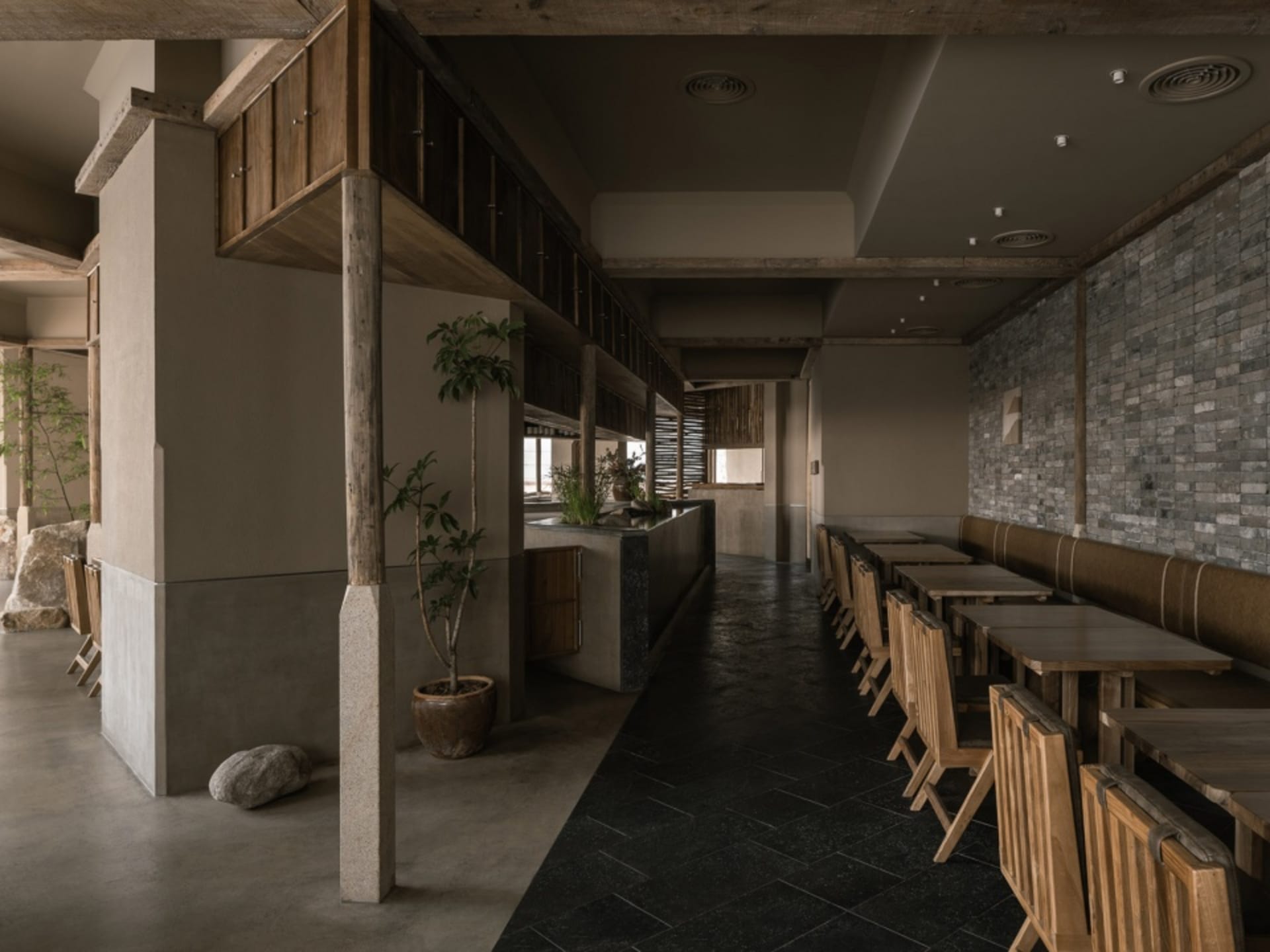 Industrial-themed restaurant interior with concrete walls and flooring
