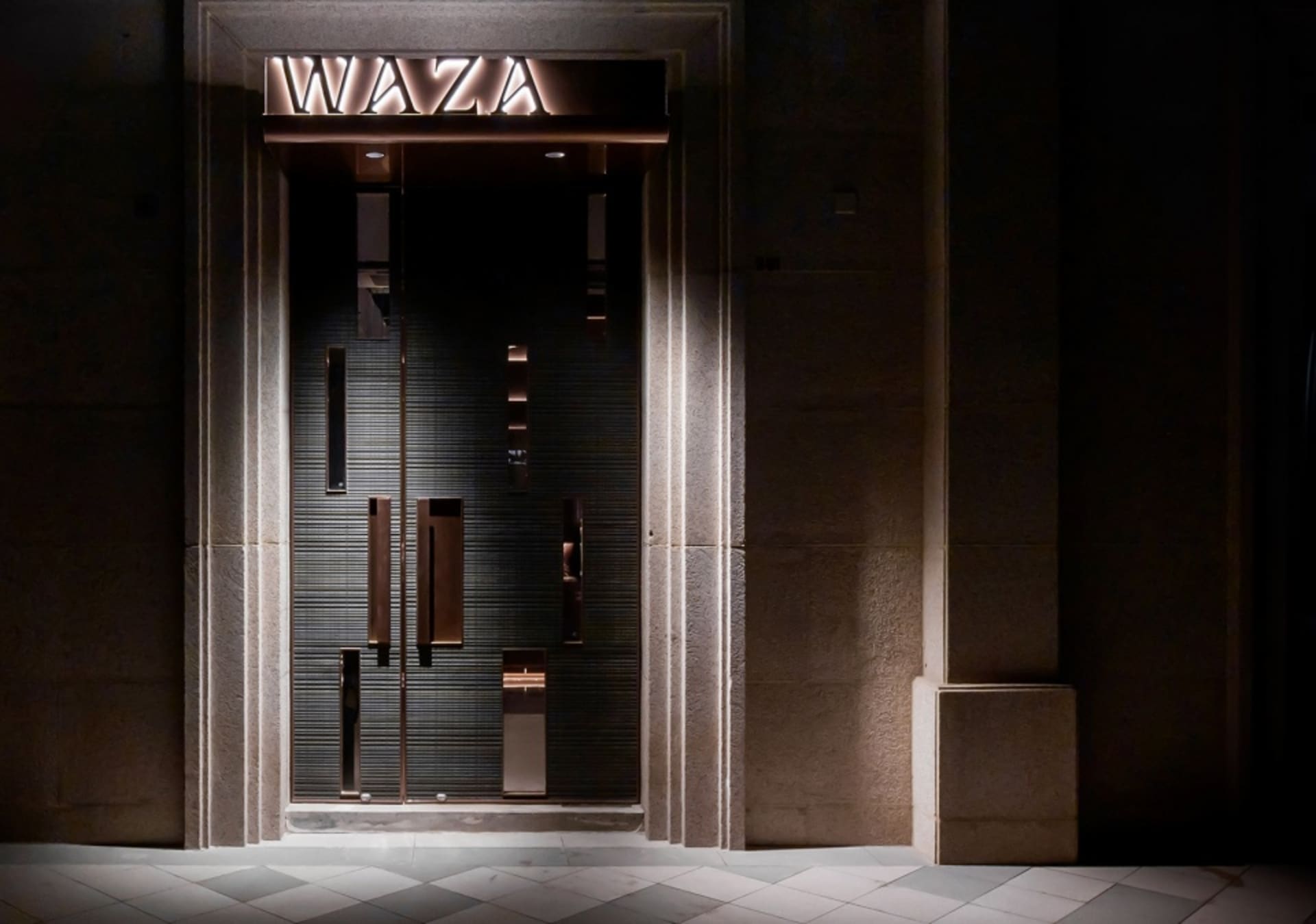 Modern storefront featuring metallic and glass elements.
