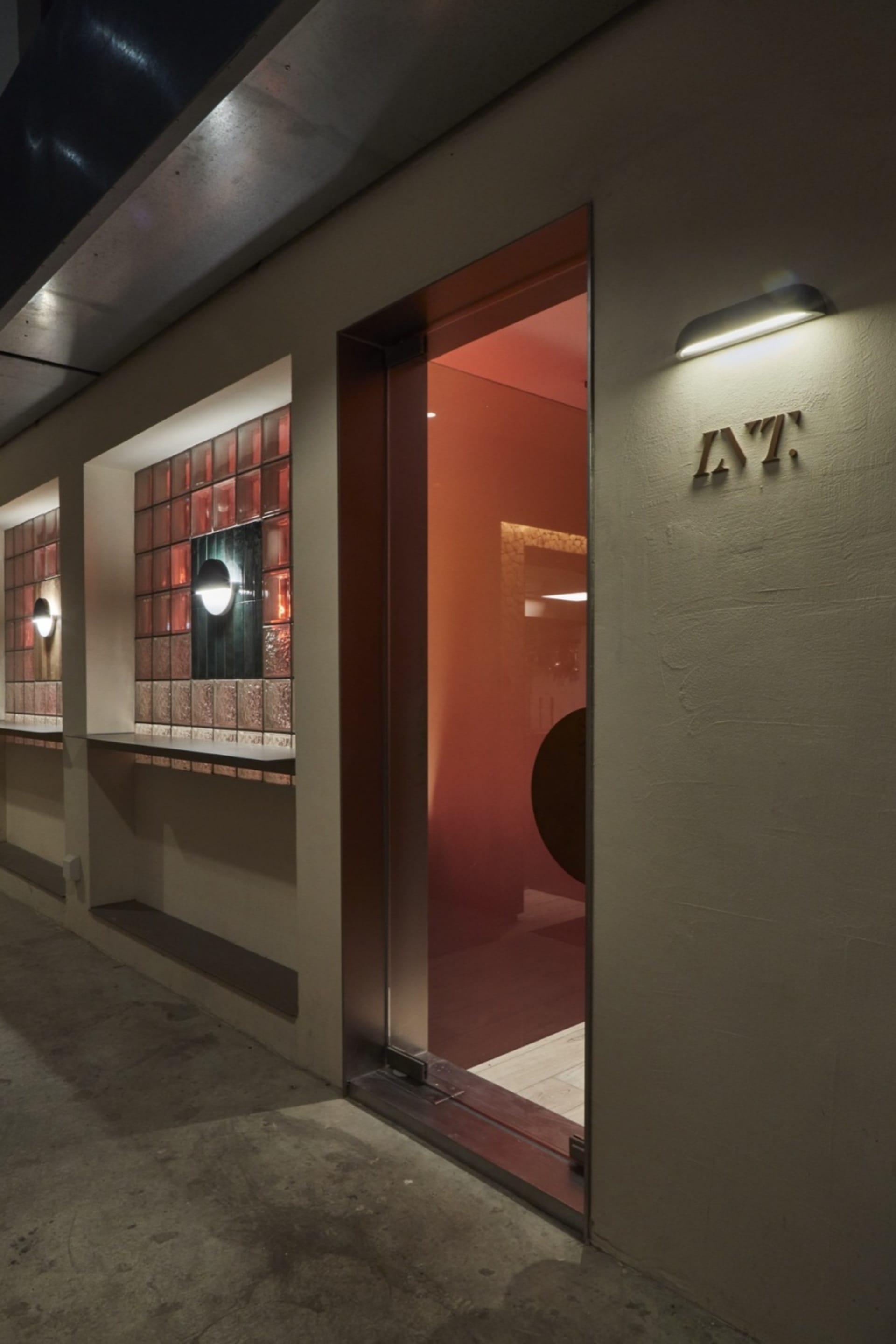 Modern building exterior featuring concrete and red materials