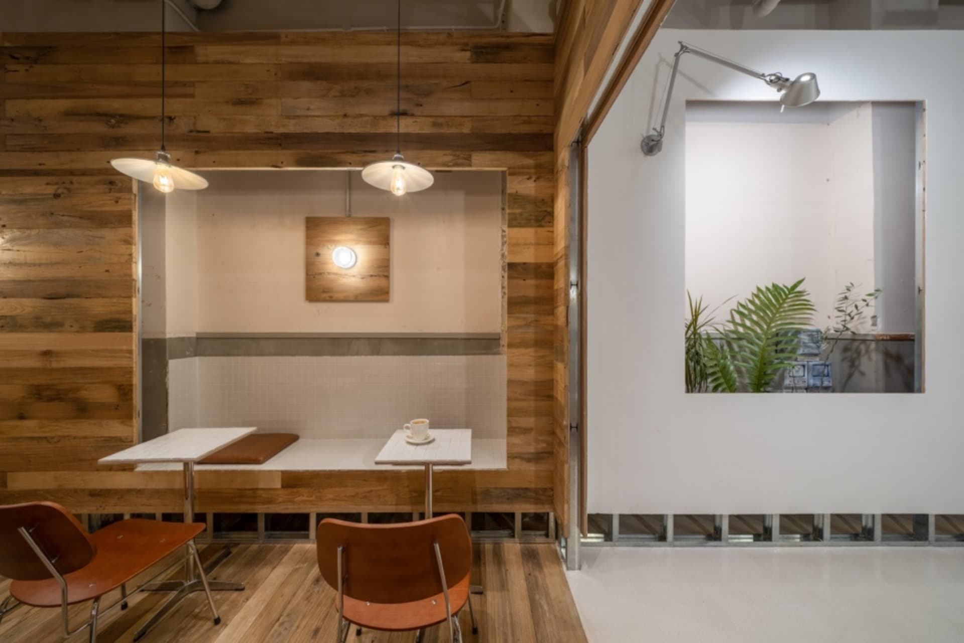 Industrial-style cafe interior featuring a wooden wall and table.