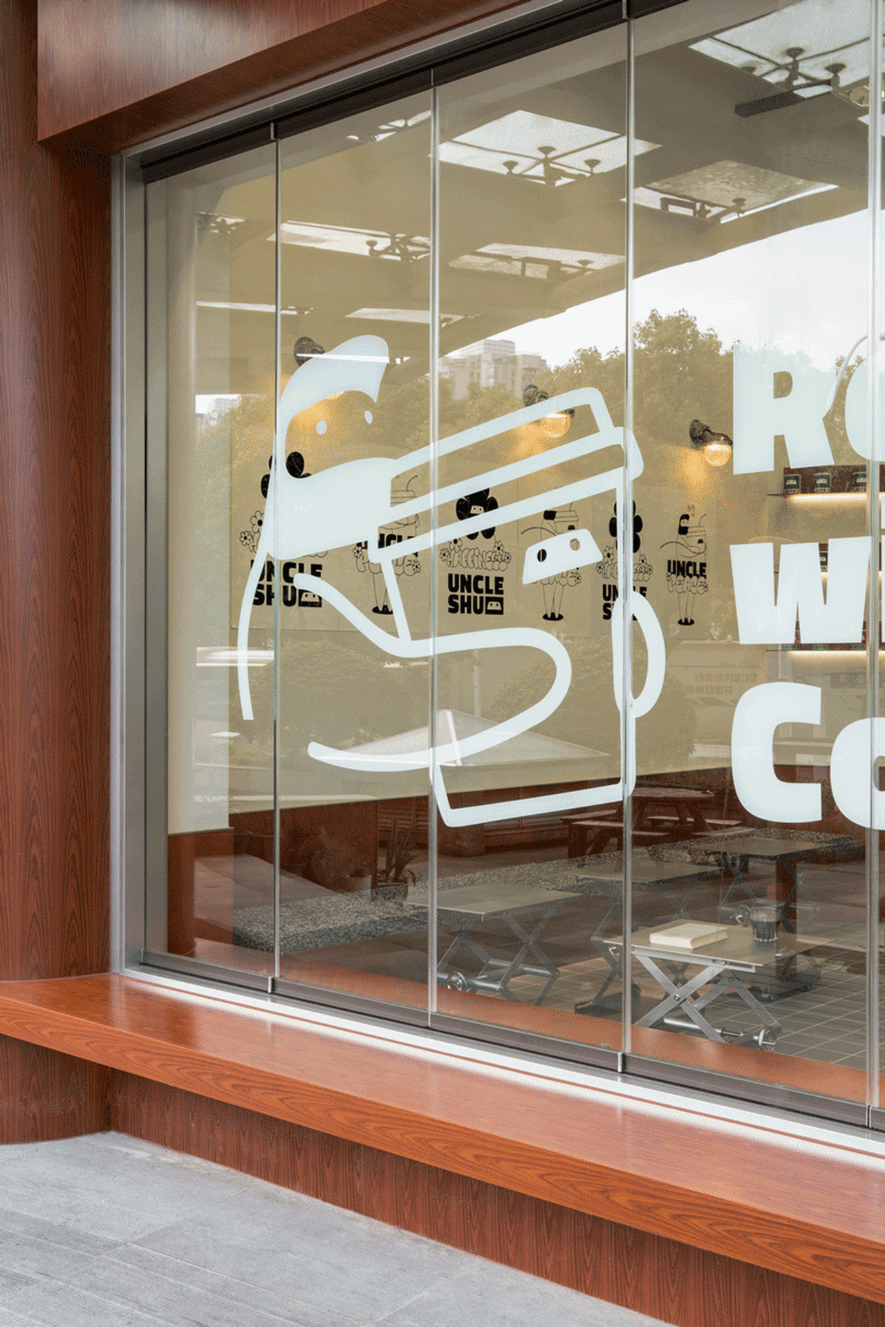 A glass window with a modern coffee shop design.