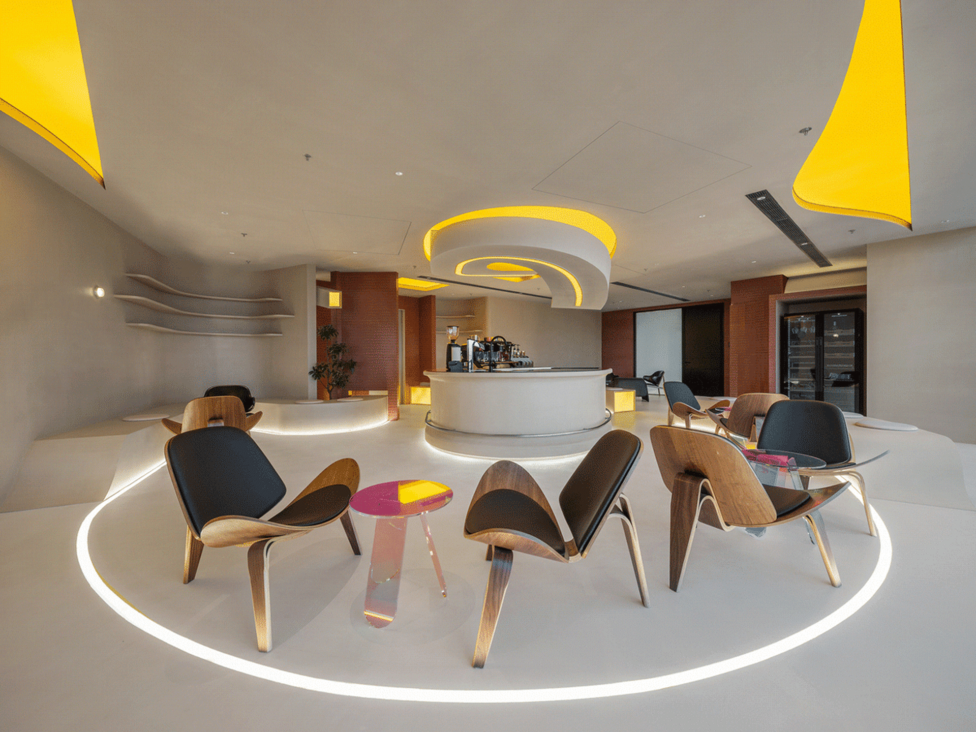 A modern, white concrete coffee shop interior with circular seating area and barista counter.