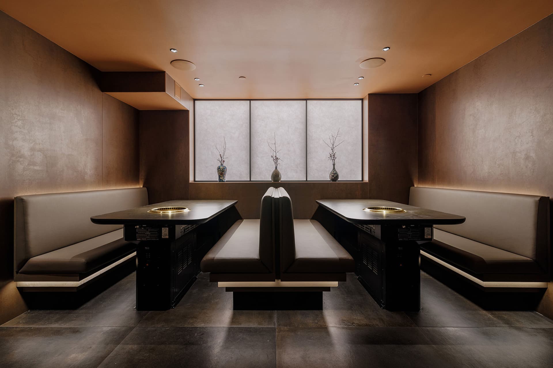 Industrial-style restaurant interior featuring concrete, wood, and metal materials.