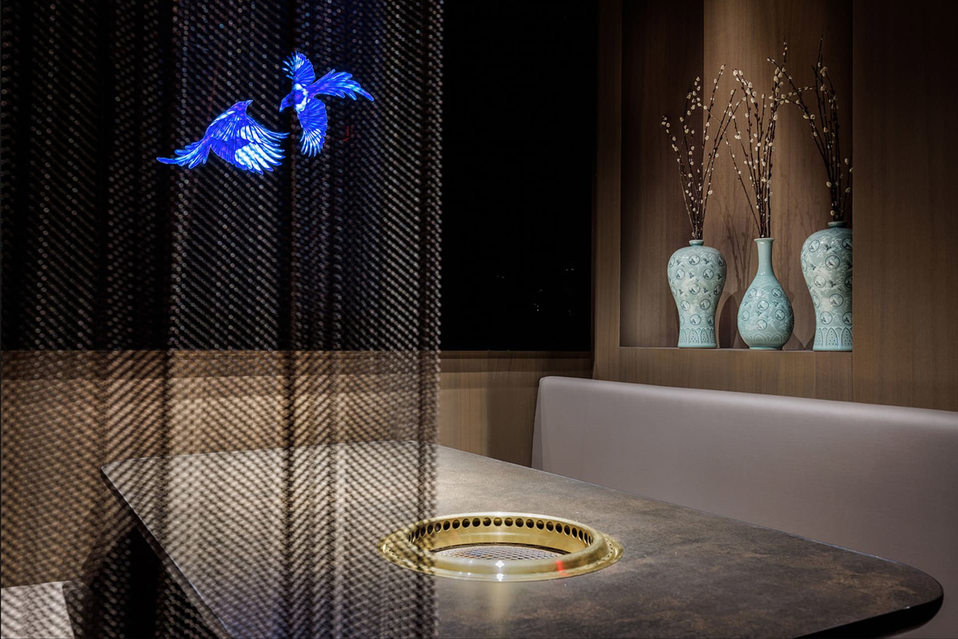 A modern restaurant interior with metal and leather elements.