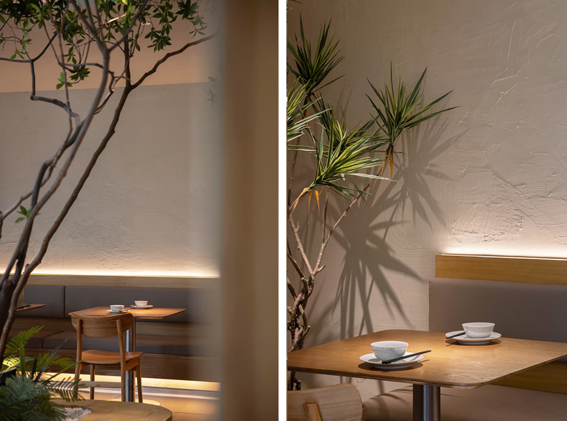 A serene restaurant interior featuring modern design elements like wood, concrete, and lush green plants.