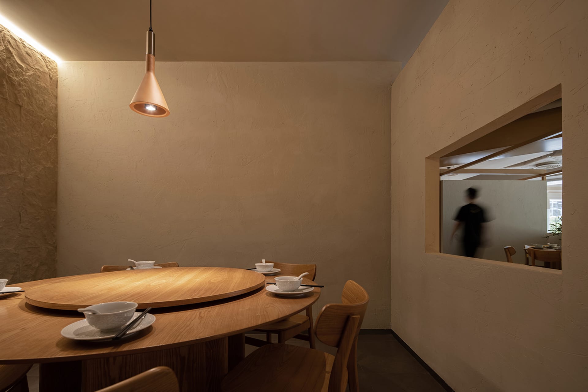 A modern restaurant interior featuring wooden furniture and a cozy atmosphere.